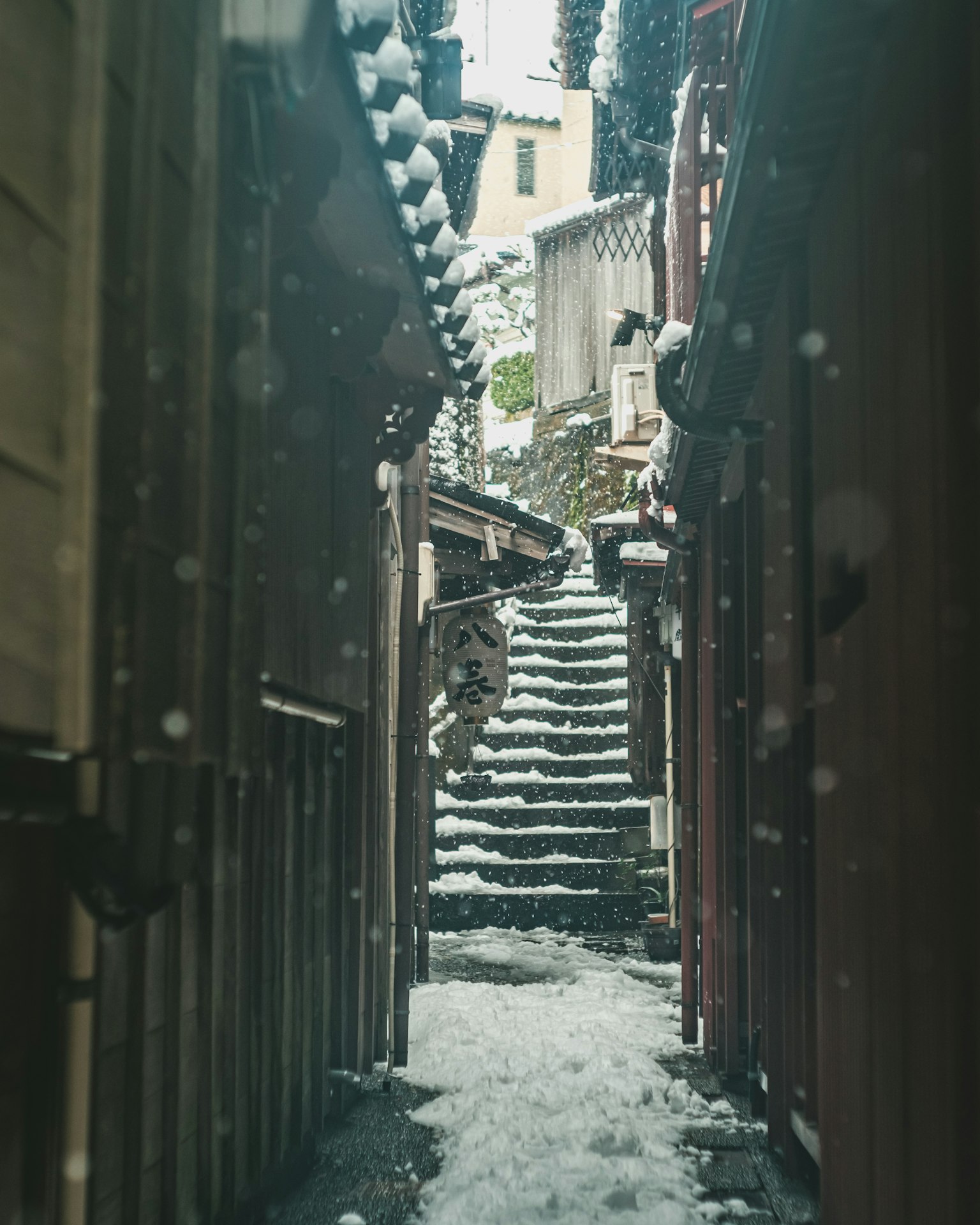 Narrow alleyway with snow-covered steps