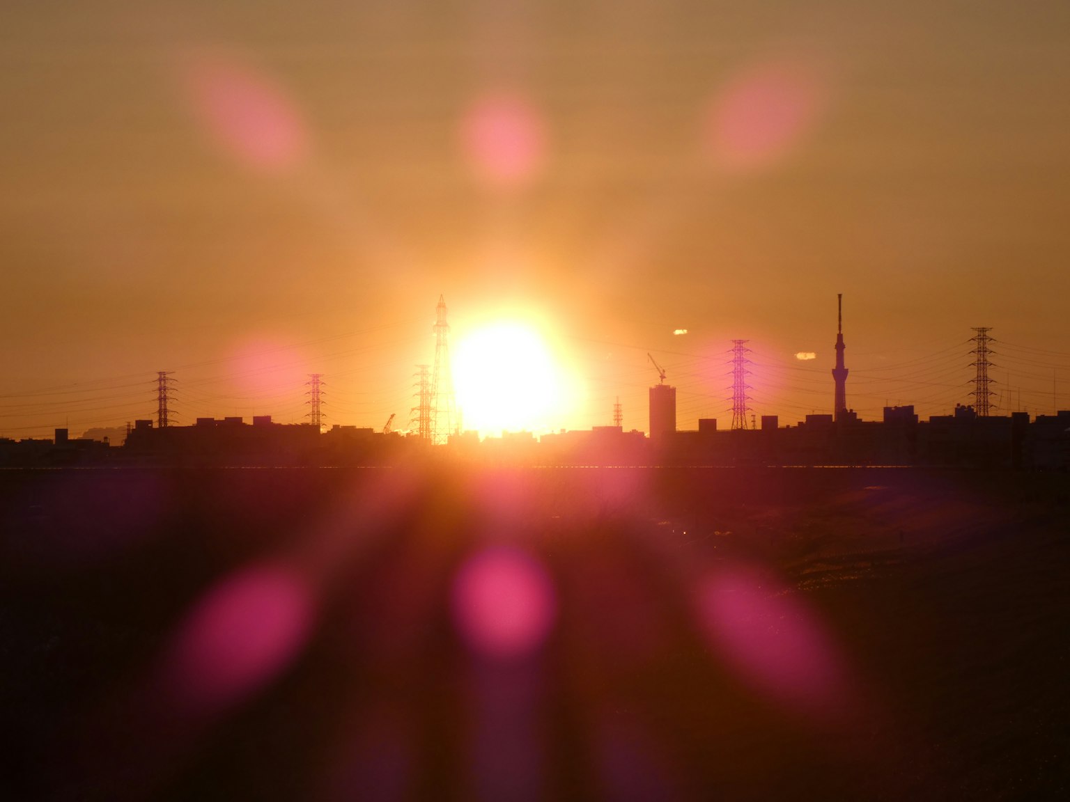 Beautiful sunset over a city skyline with silhouettes of towers
