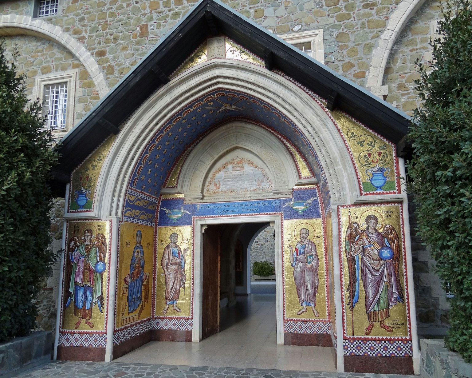 Architectural entrance featuring intricate mosaics and an arched doorway
