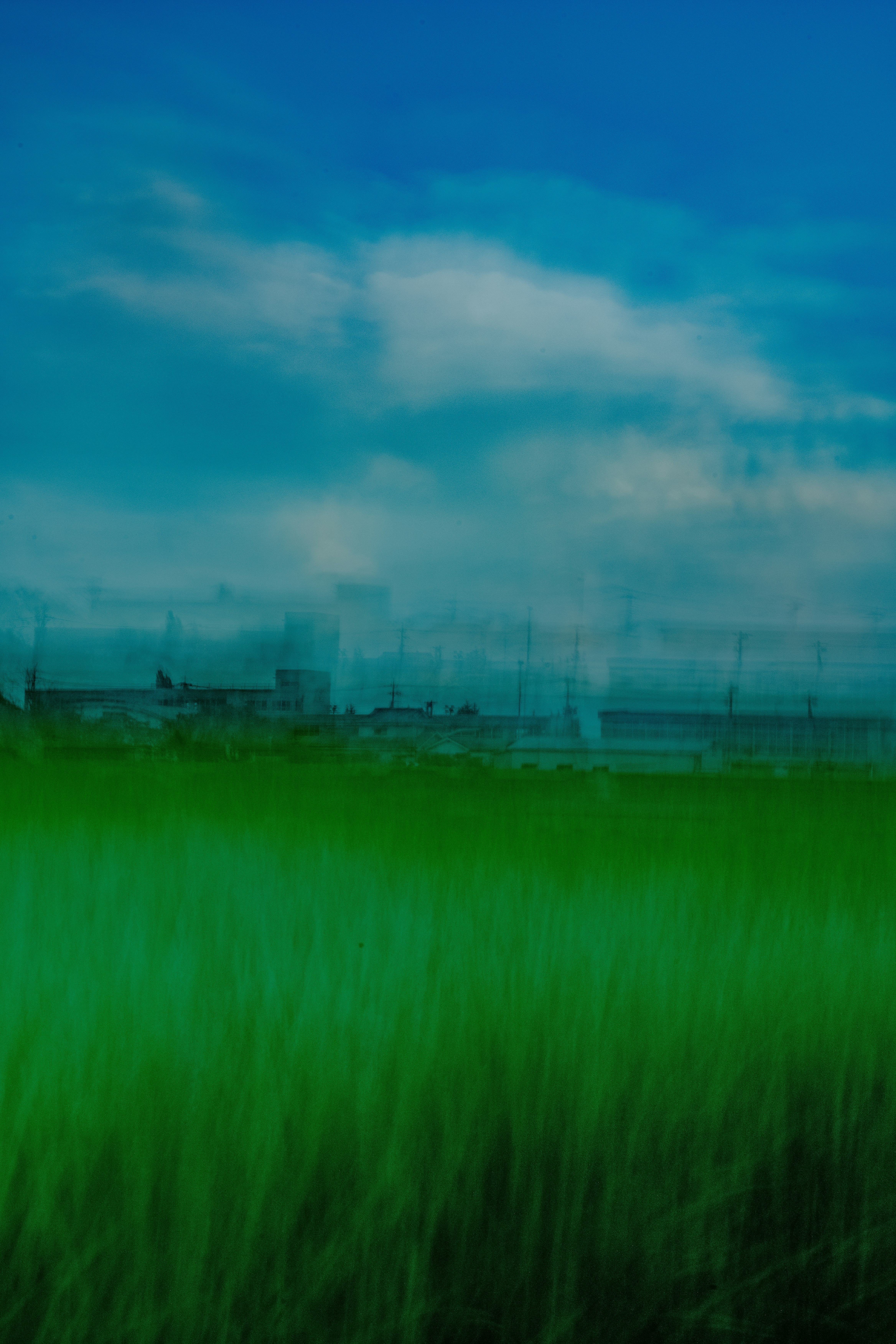 Green field with distant city skyline landscape