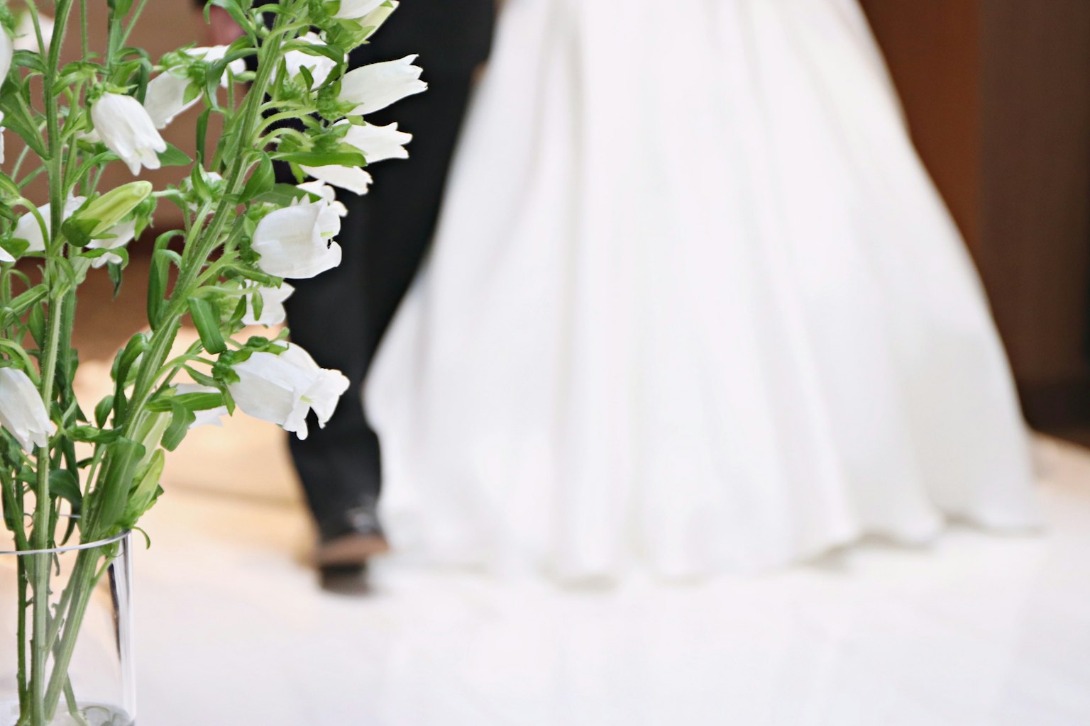 Close-up of white flowers and wedding dress