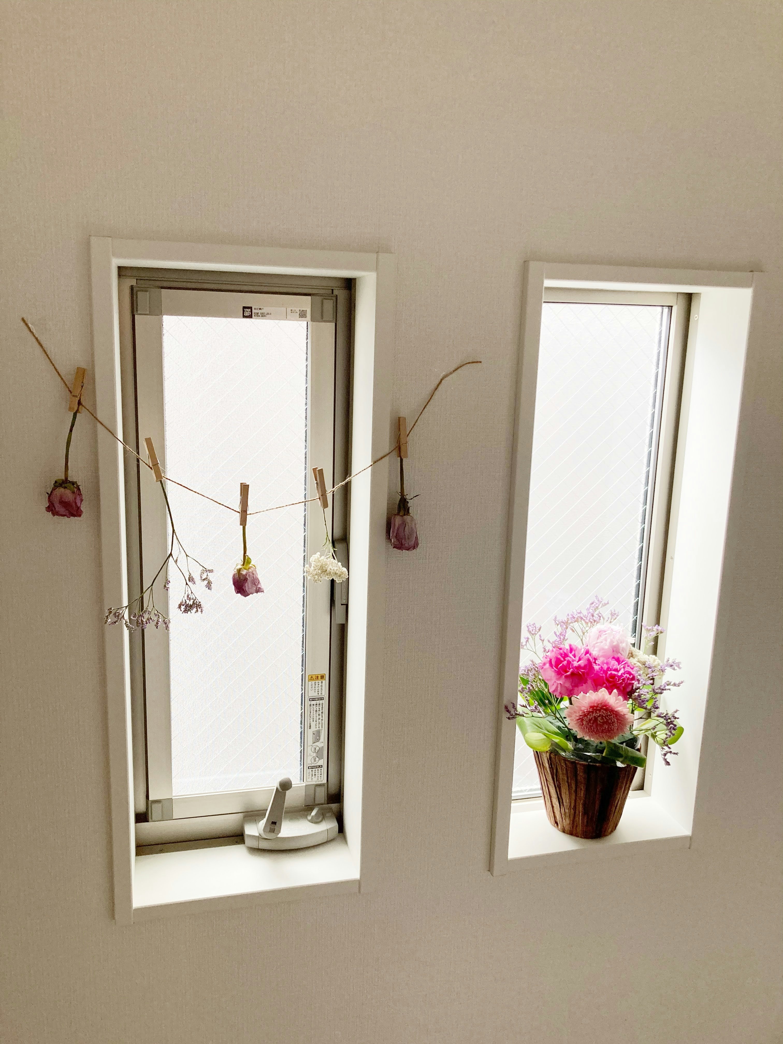 Indoor window ledge with flowers and a small vase