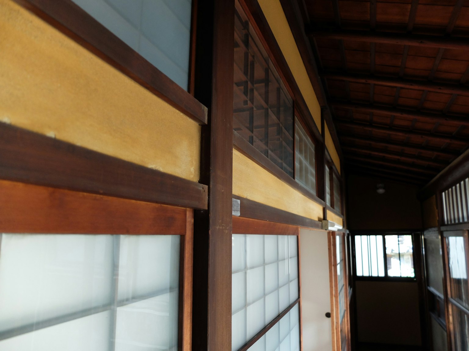 Interior hallway of a traditional Japanese house featuring wooden frames and shoji doors