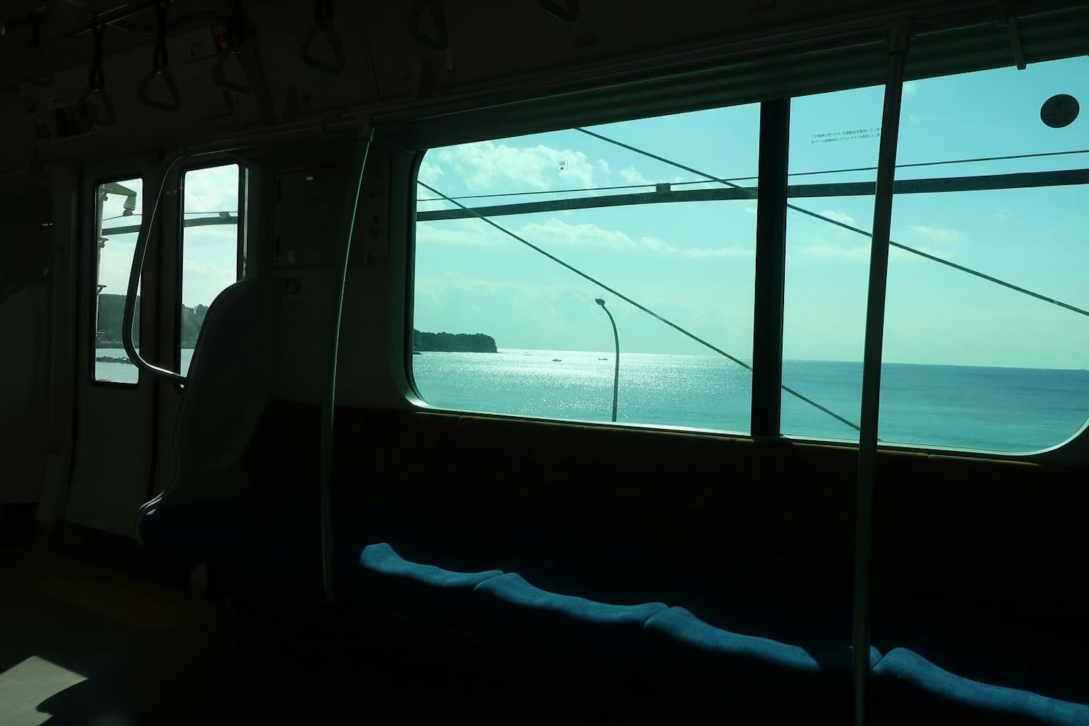 Interior of a train with a view of the sea