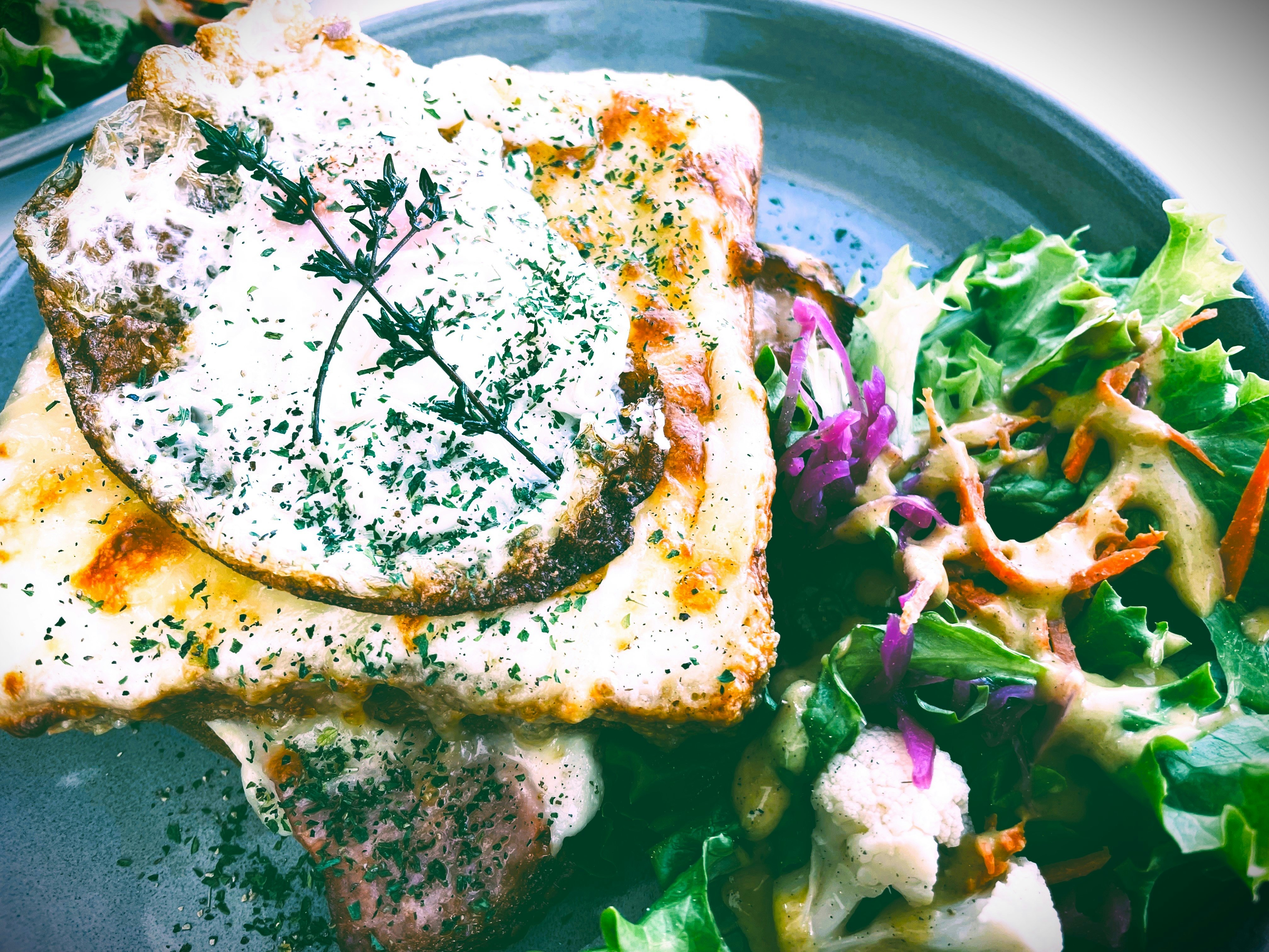 Madame-style croque with salad on a plate