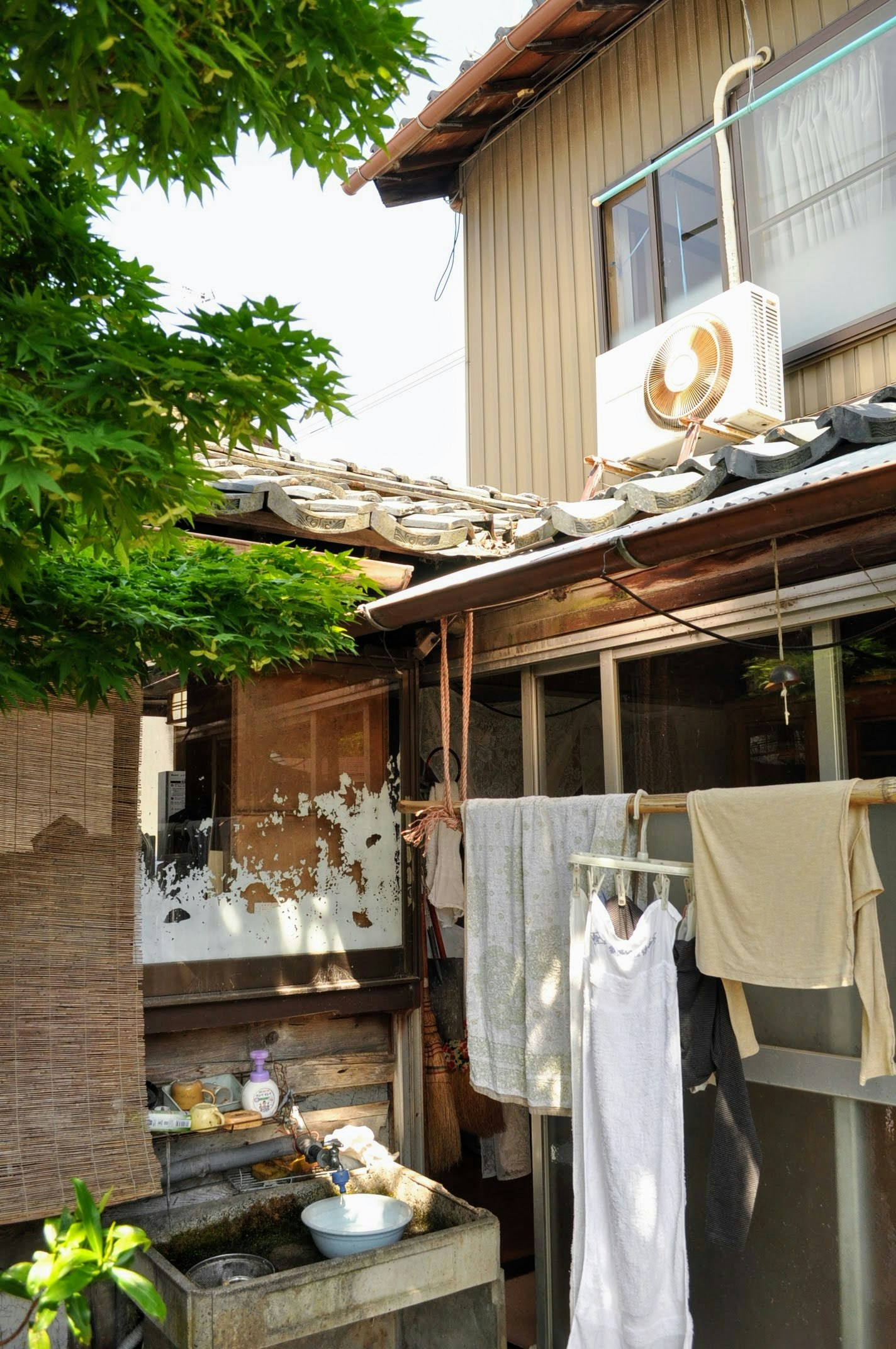 exterior of an old house with laundry hanging in a courtyard