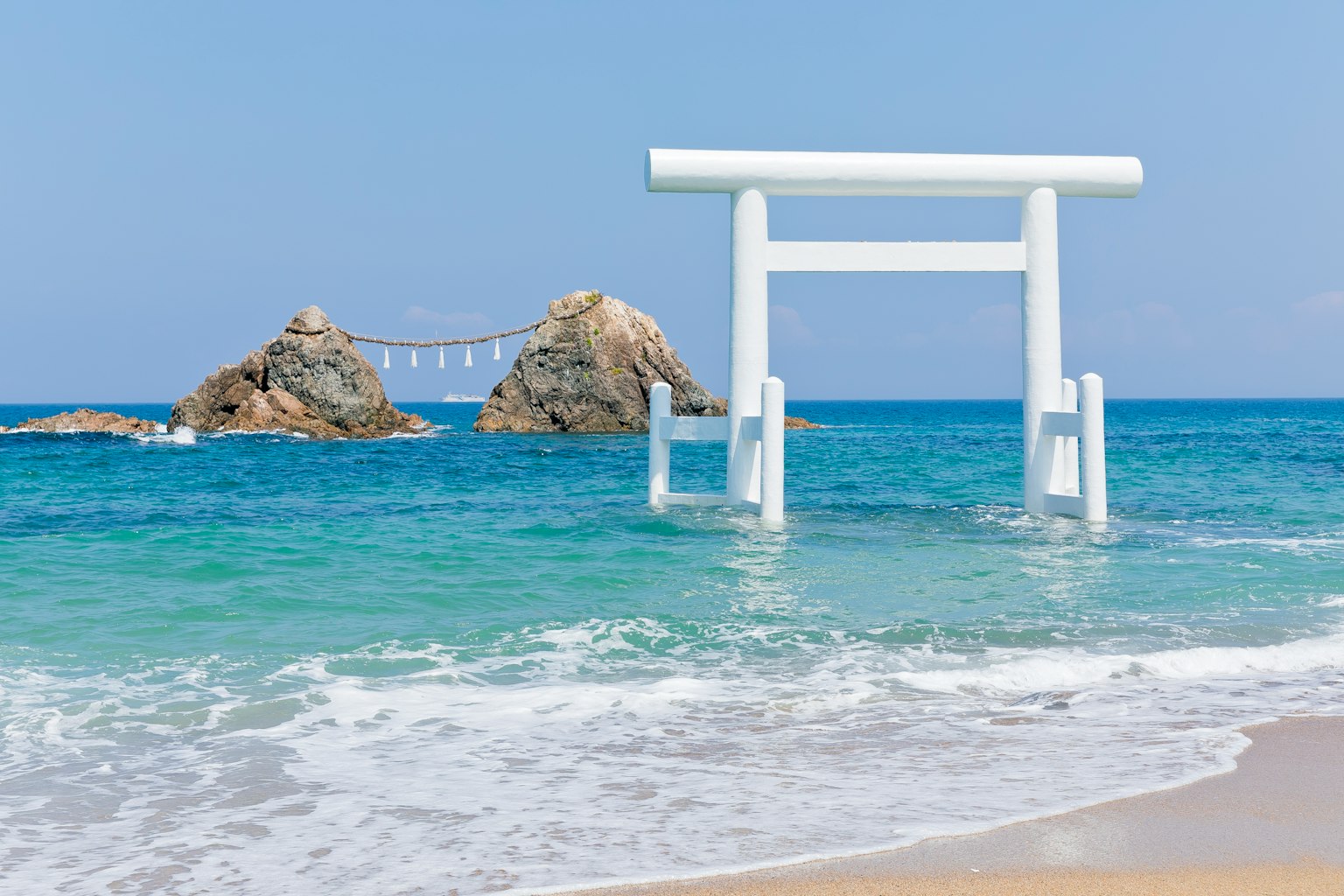 Portique torii blanc se tenant près de l'océan