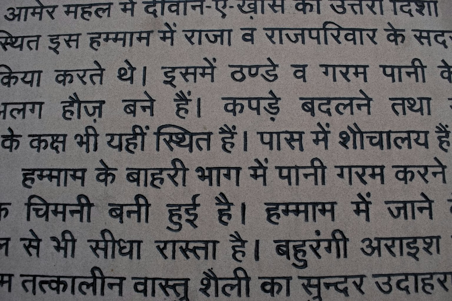 The image features Hindi text discussing hot water and shower facilities