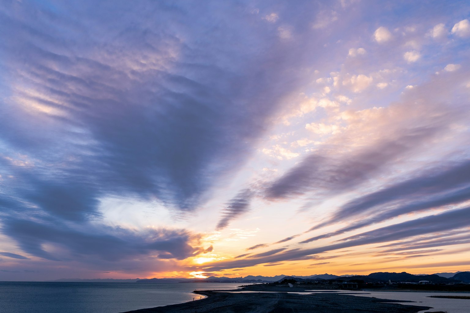 Scenic view of a vibrant sunset sky with clouds and ocean