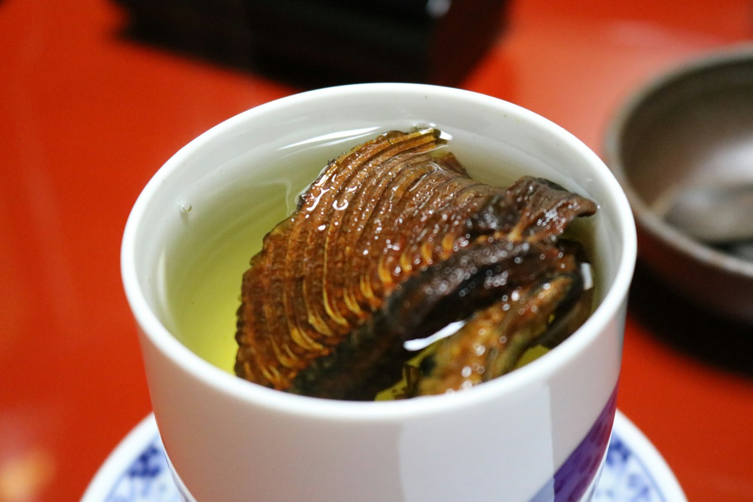 Una tazza di tè con pesce secco all'interno
