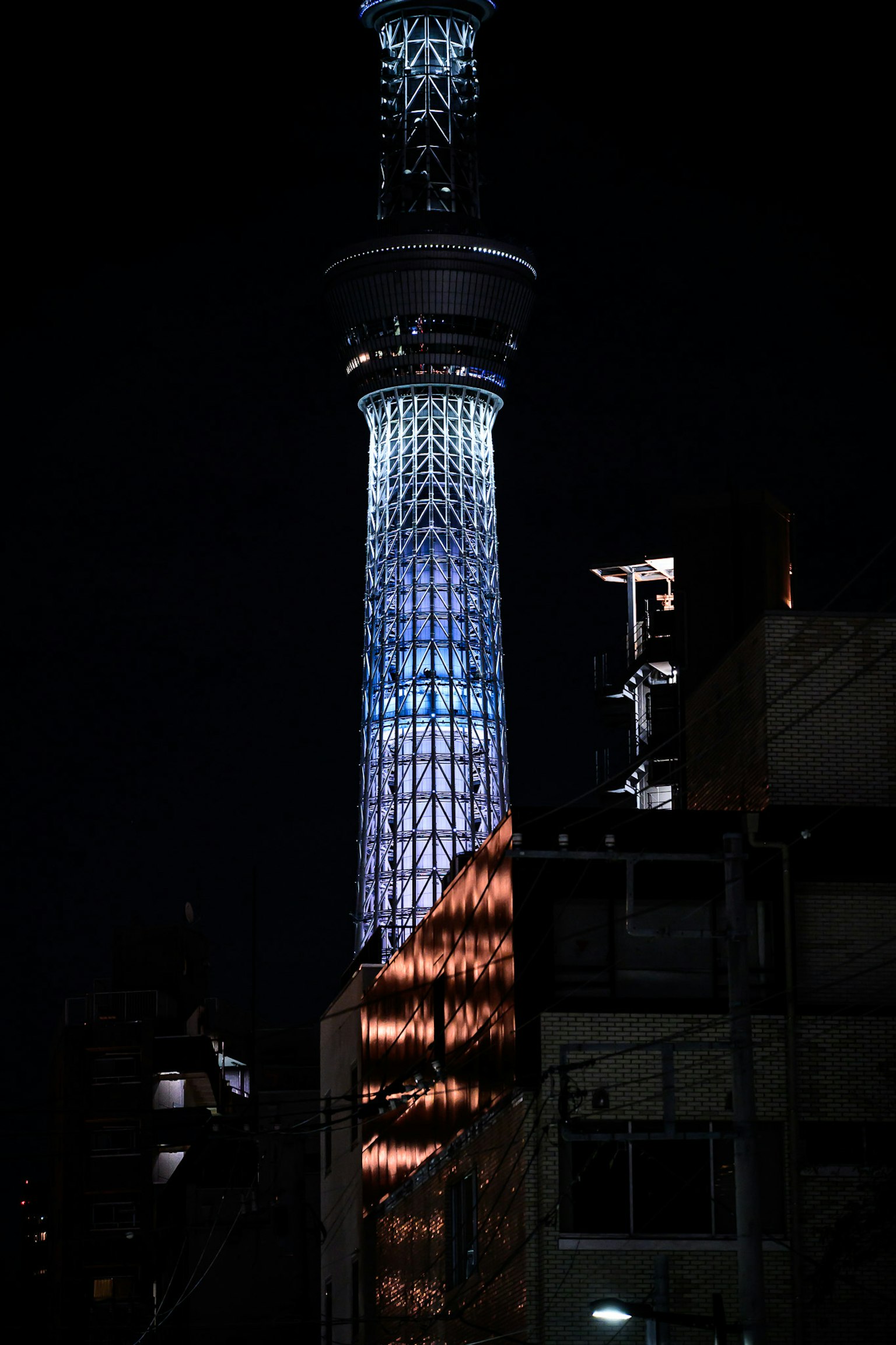 Tokyo Skytree illuminated at night showcasing vibrant colors