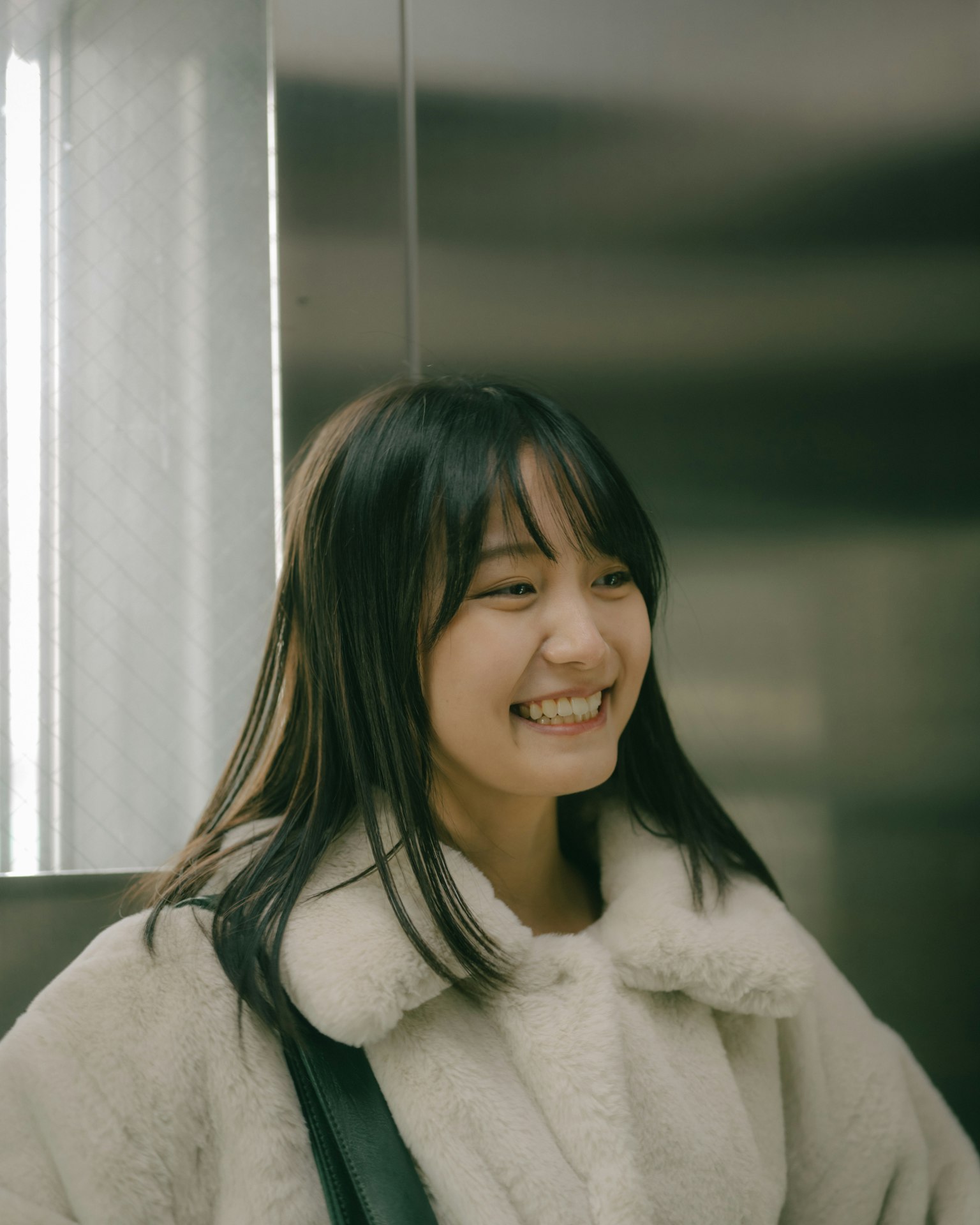 Portrait of a smiling woman in an elevator