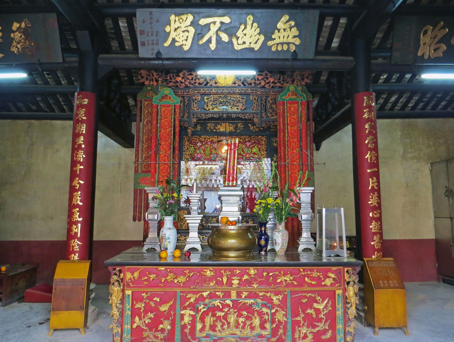 Traditional temple interior with ornate altar and decorations