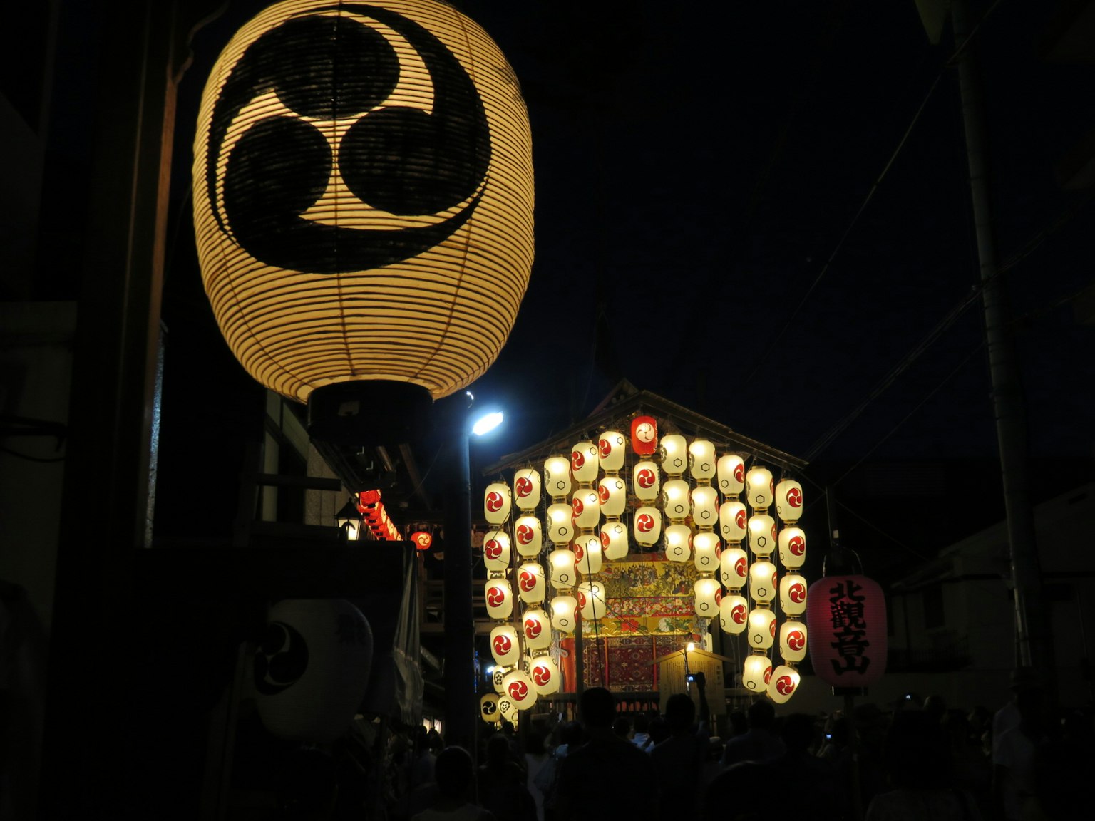 Lanterns illuminating the streets at night with festival decorations