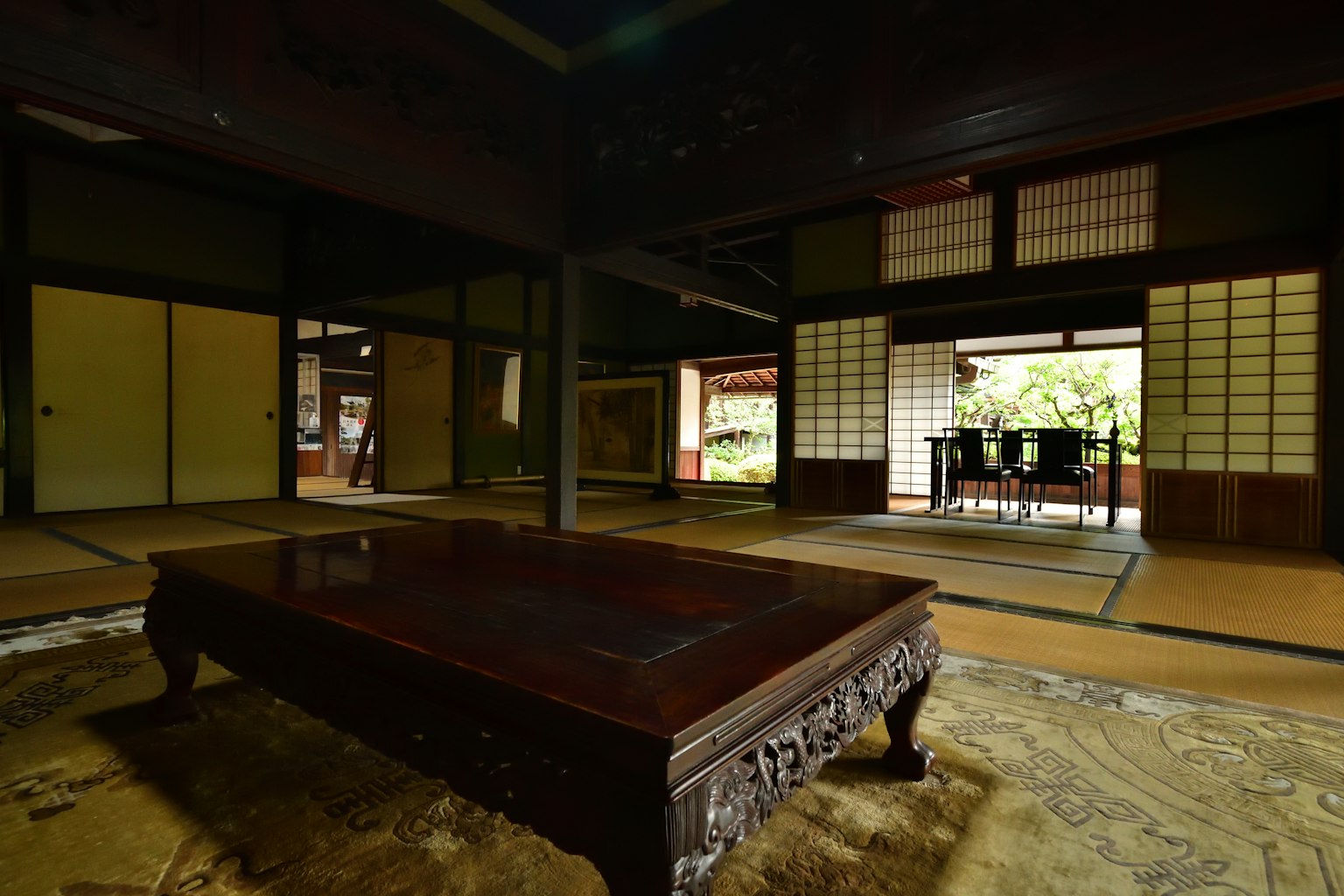 Traditional Japanese room interior with wooden table shoji screens tatami mats garden view