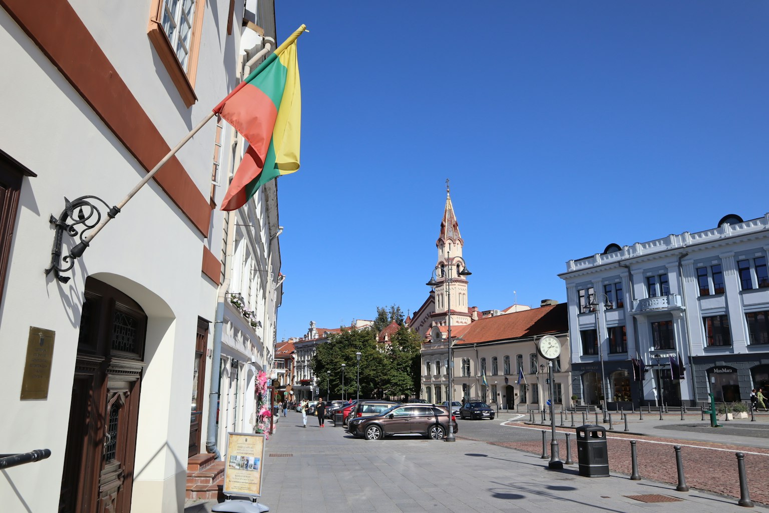 Lithuanian street scene with a church tower under a blue sky
