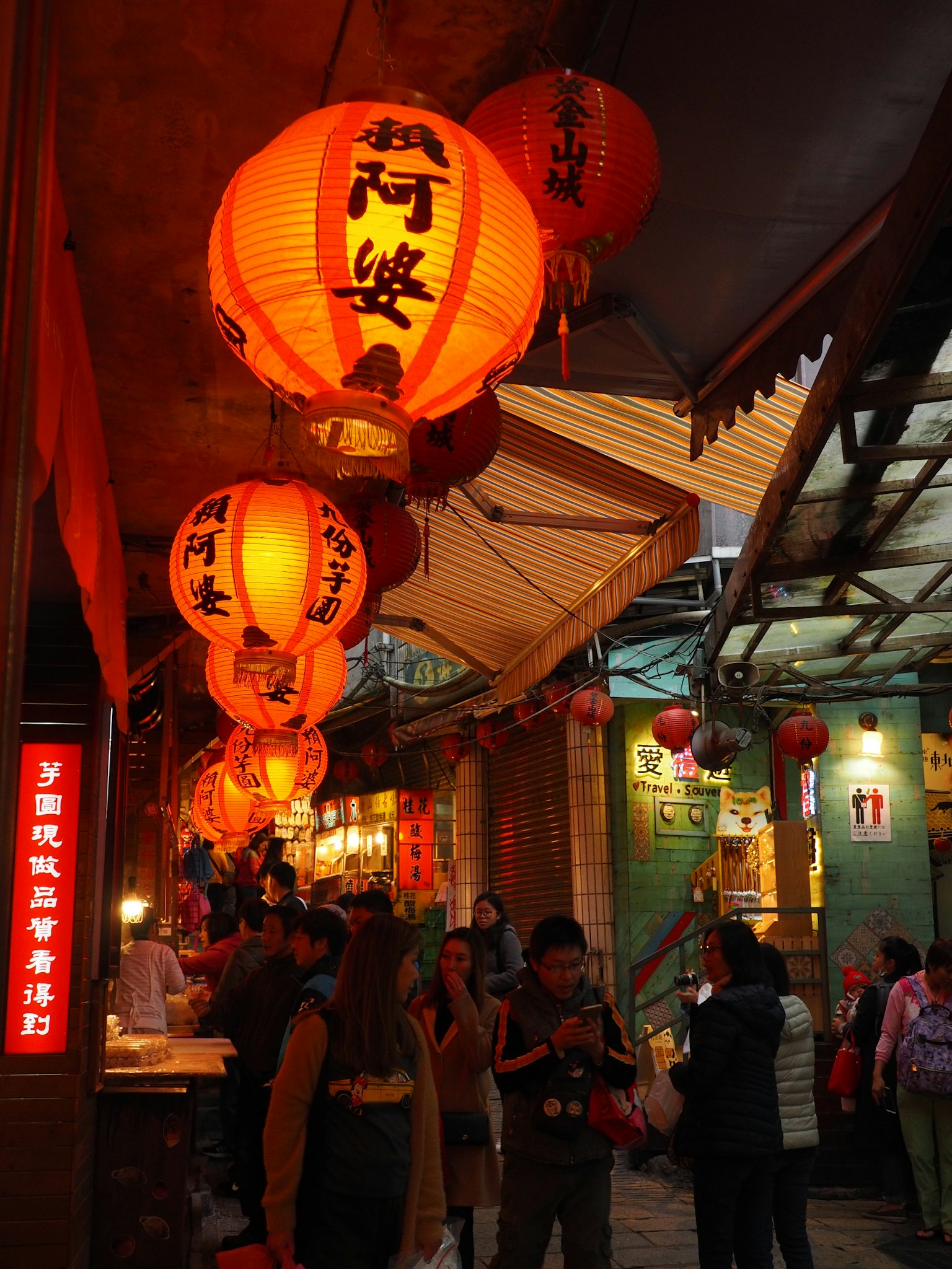 Scène de marché animé avec des lanternes rouges et des personnes marchant