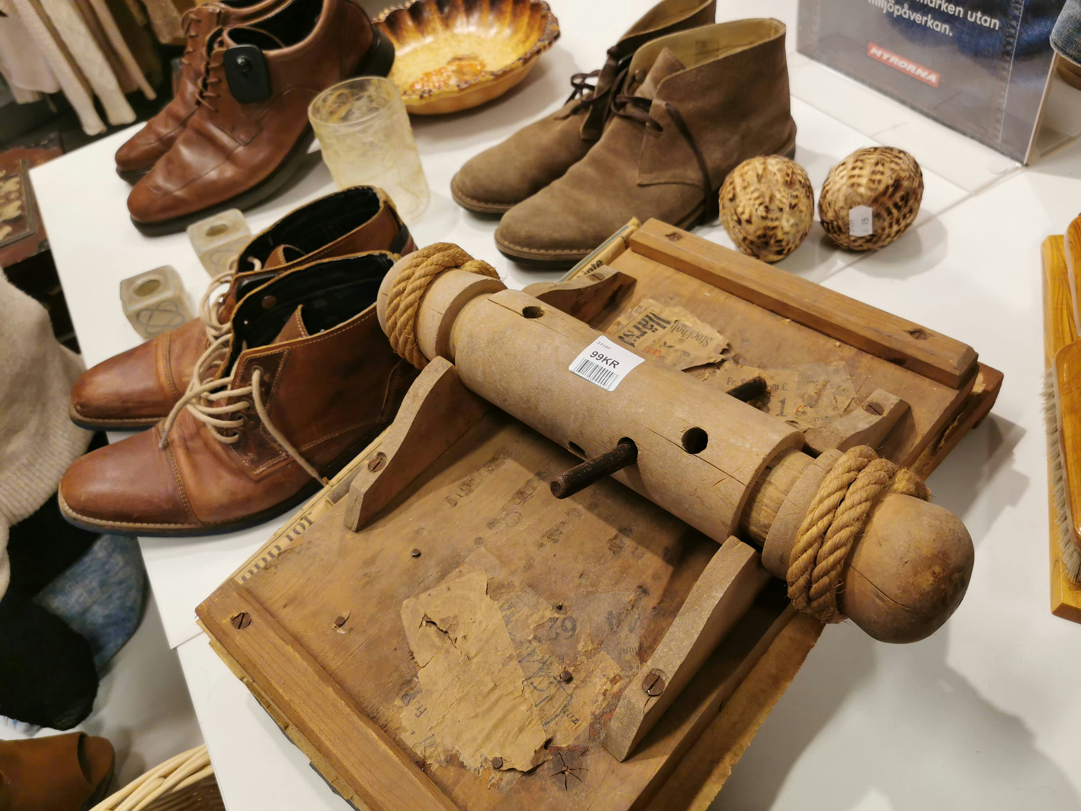 tavolo espositivo con scarpe in pelle e attrezzi in legno