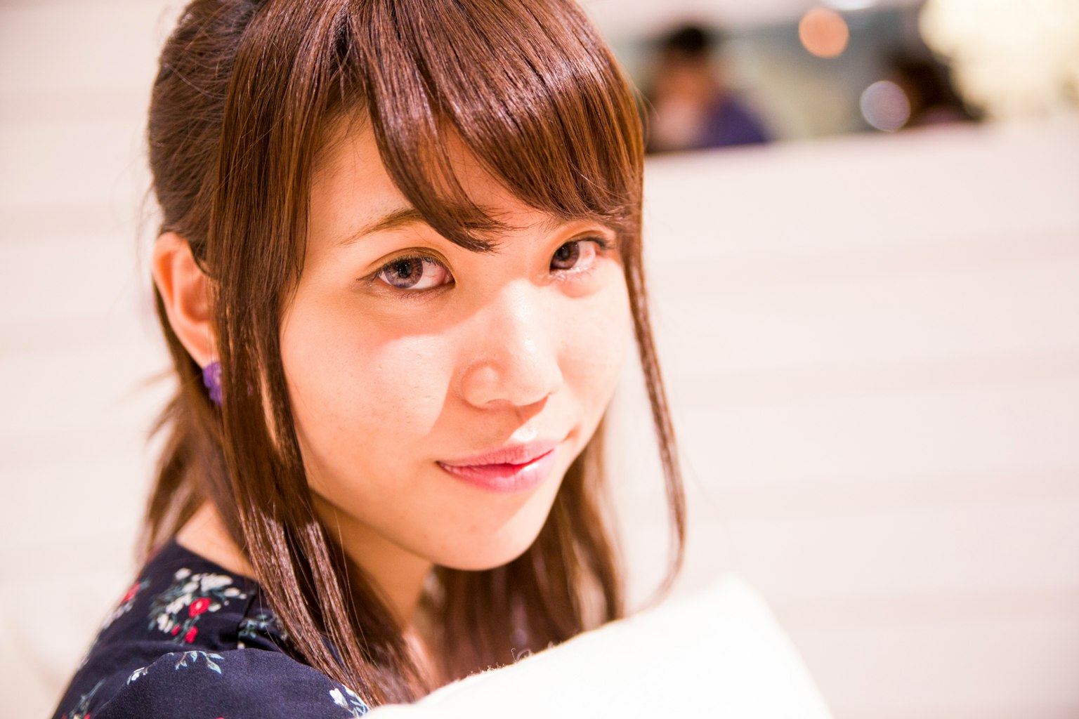 A woman smiling and looking at the camera