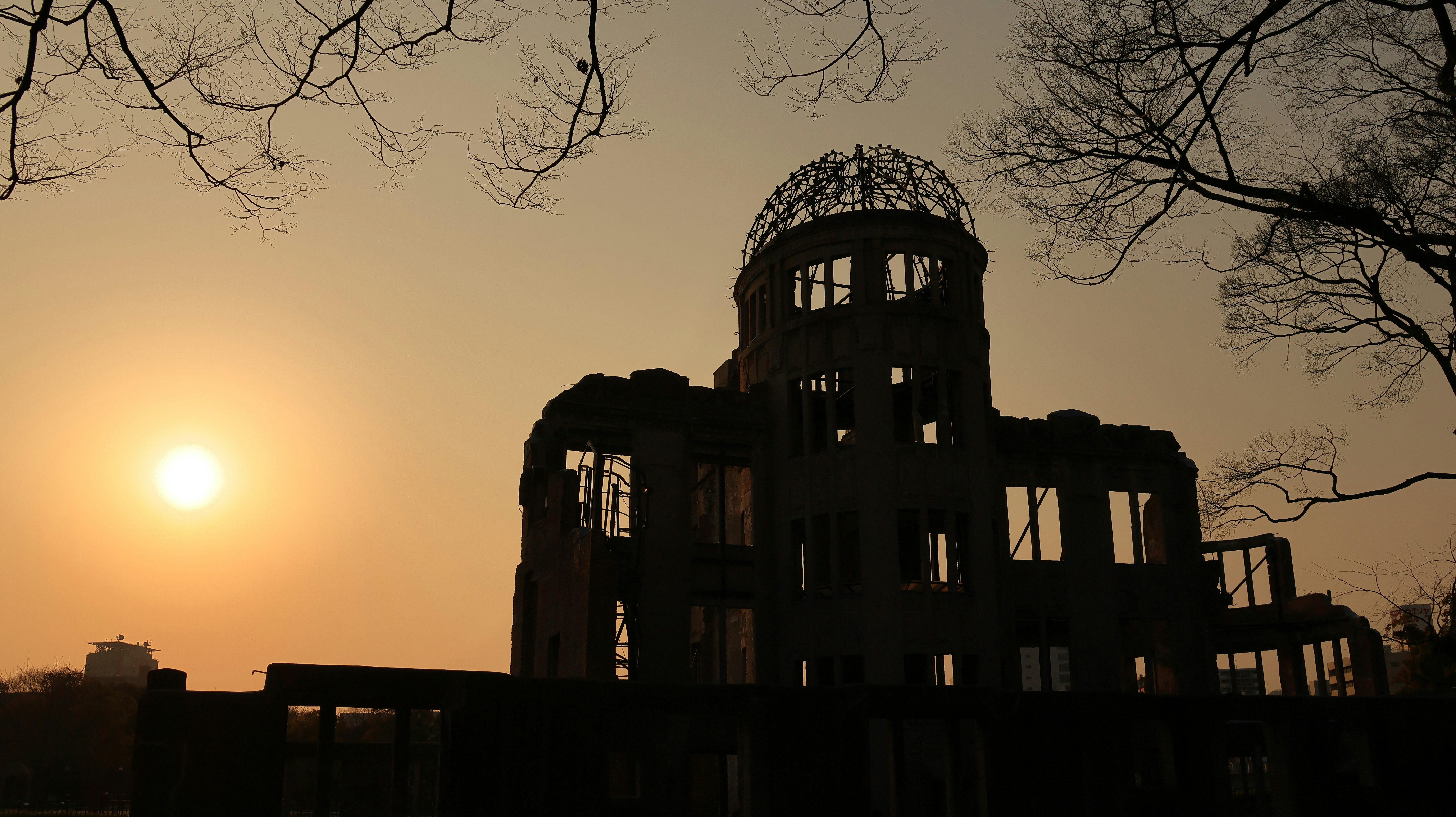 dome-shaped ruined building against a sunset sky