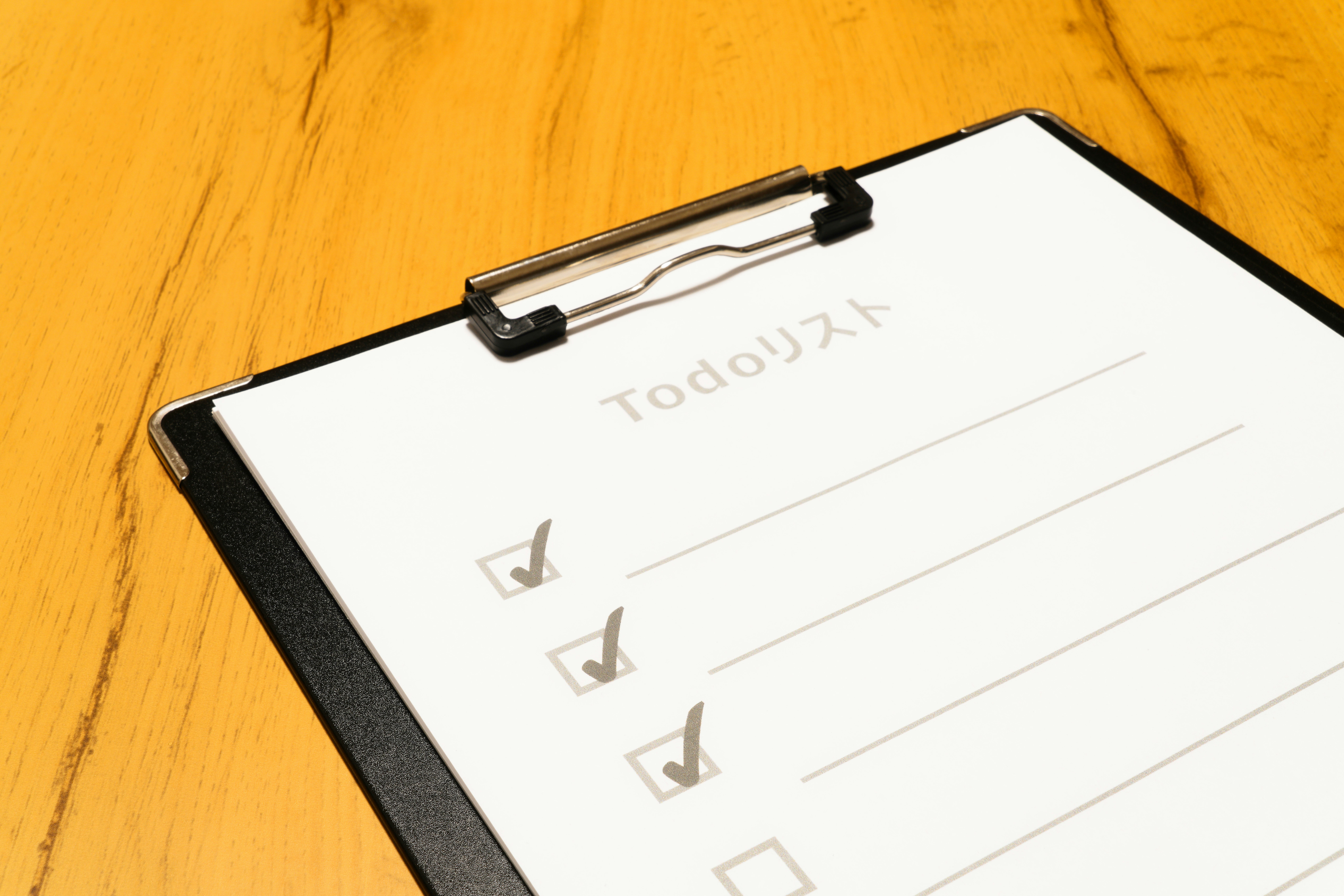 clipboard with document on a wooden desk