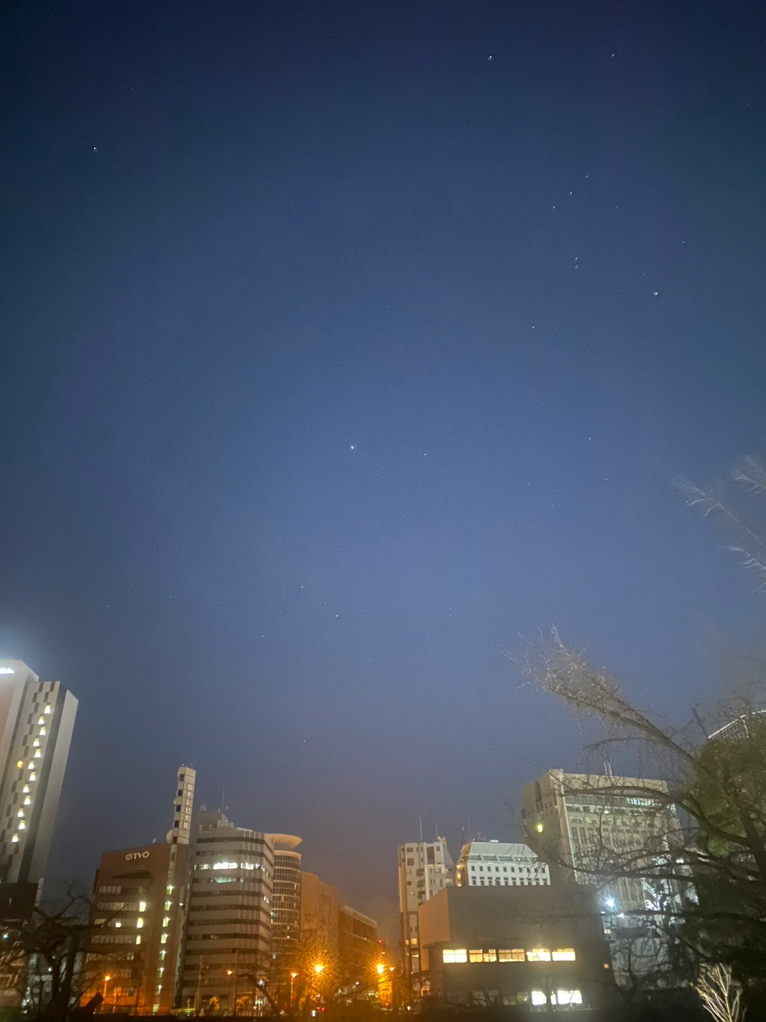 night city skyline with illuminated high-rise buildings under a clear sky