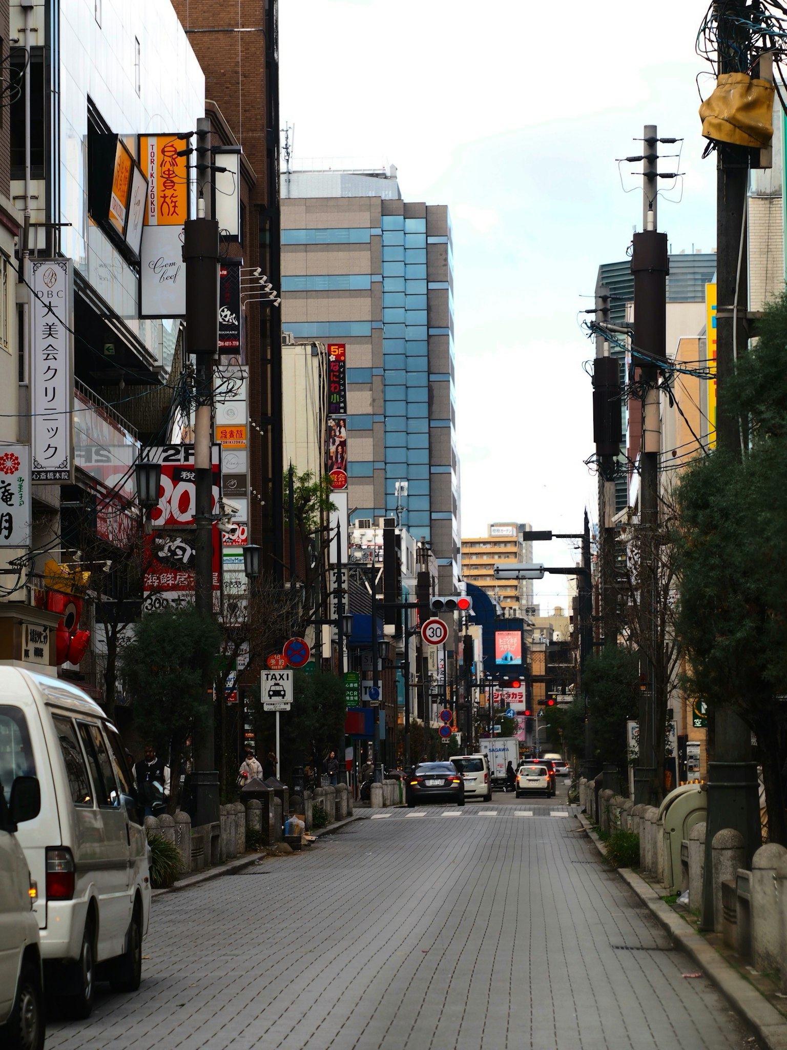 Bustling urban street lined with commercial buildings and vehicles