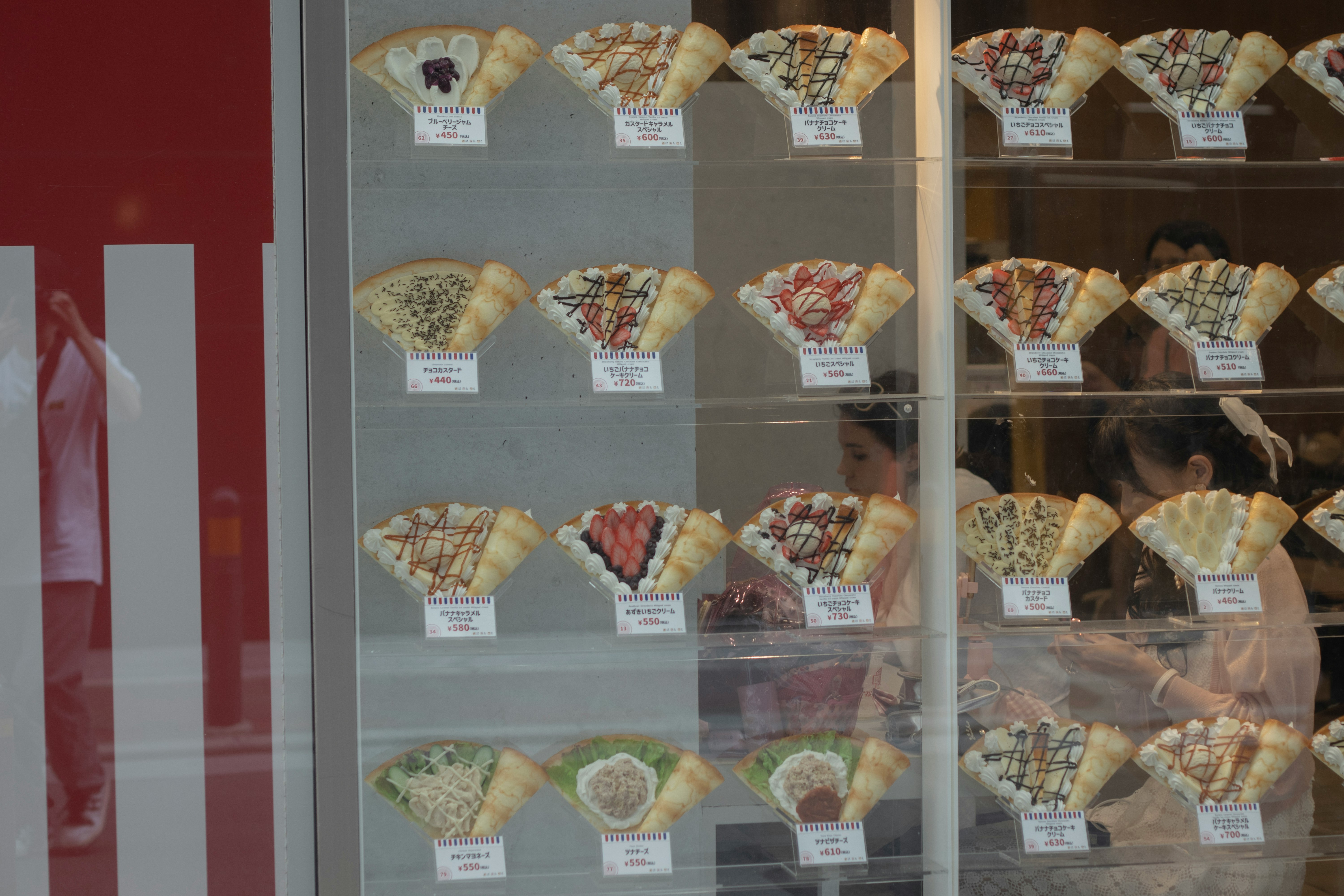 assorted baked pastries displayed in a glass case