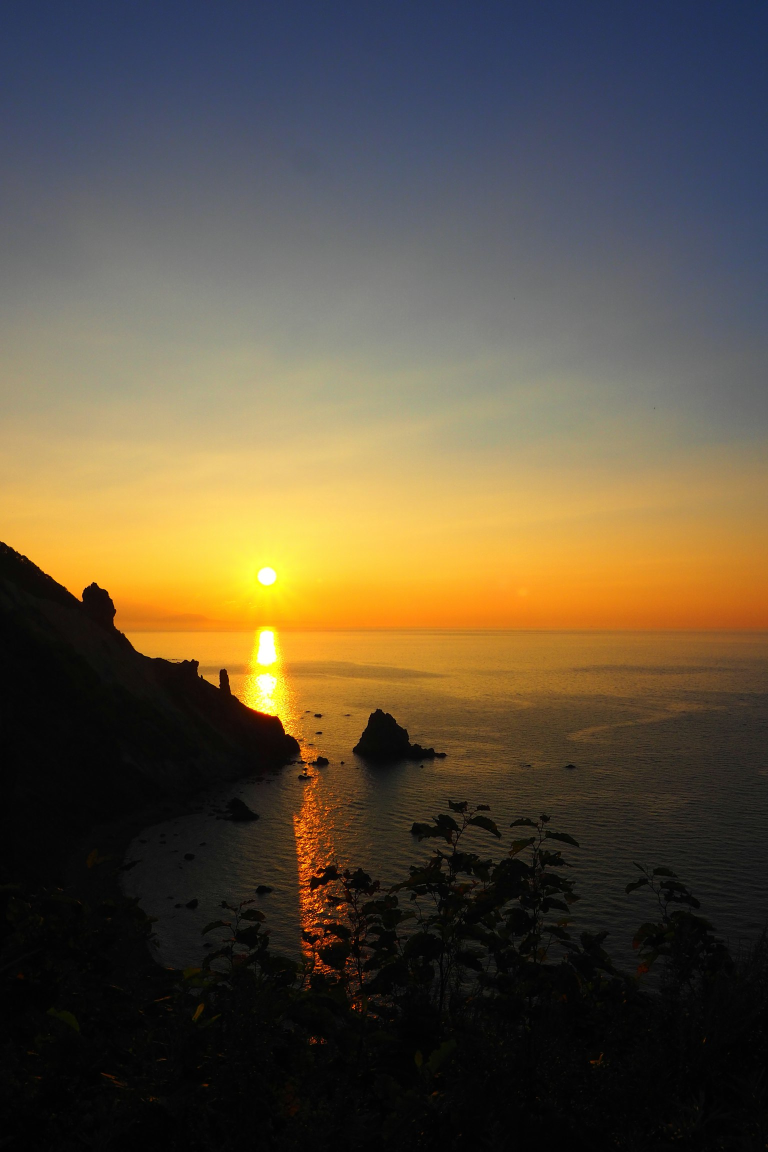 Beautiful landscape of sunset over the sea with rocks and warm colors