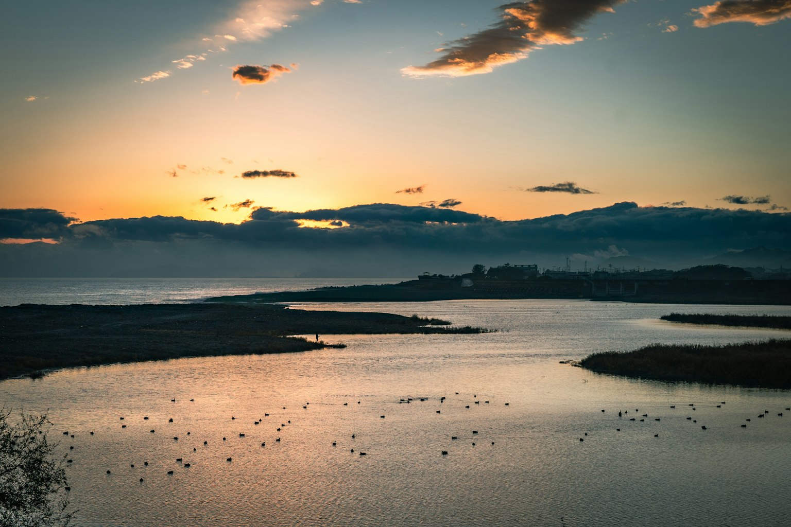 Beautiful landscape of a sunset over the sea and a calm river