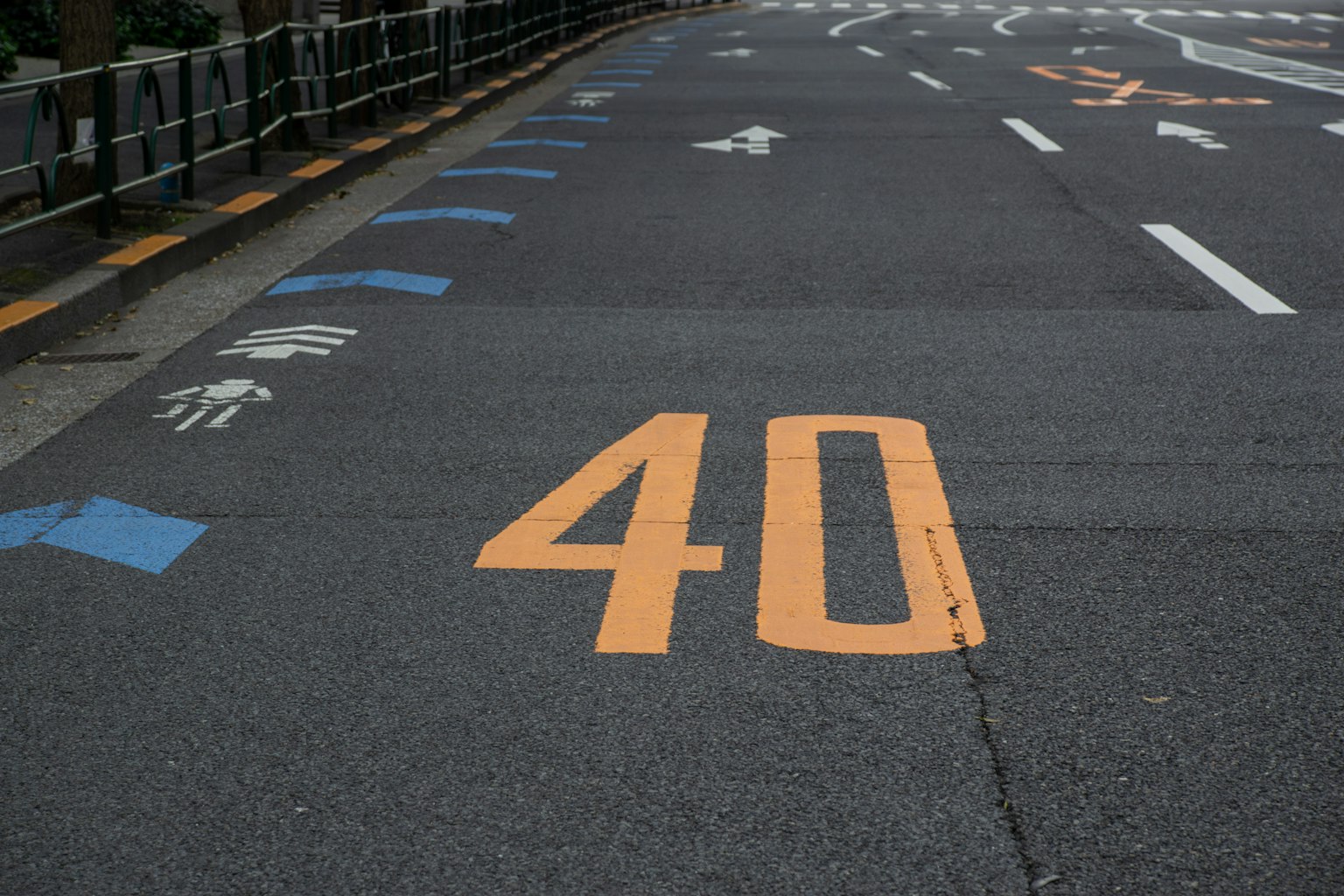 Orange number 40 painted on the road with blue markings