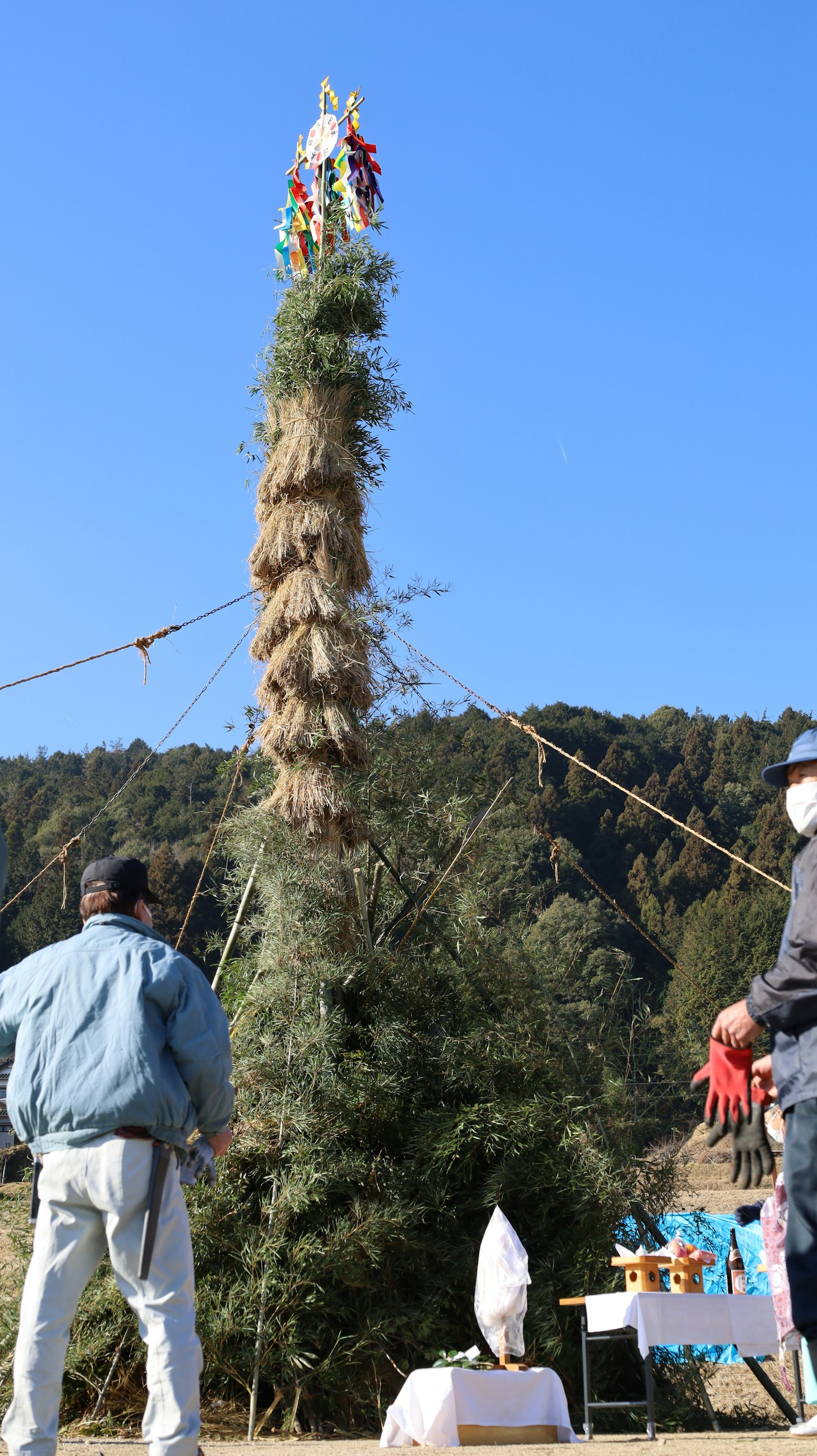 Hombres trabajando alrededor de una alta torre de madera decorada