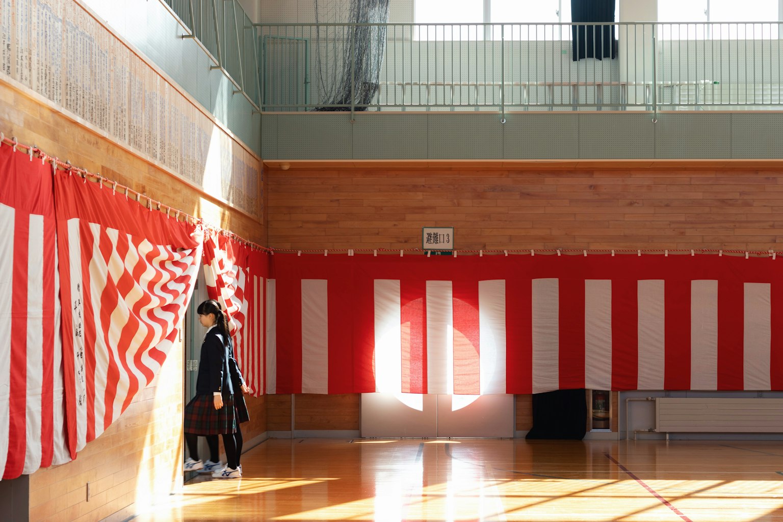 Bright gymnasium featuring red and white curtains