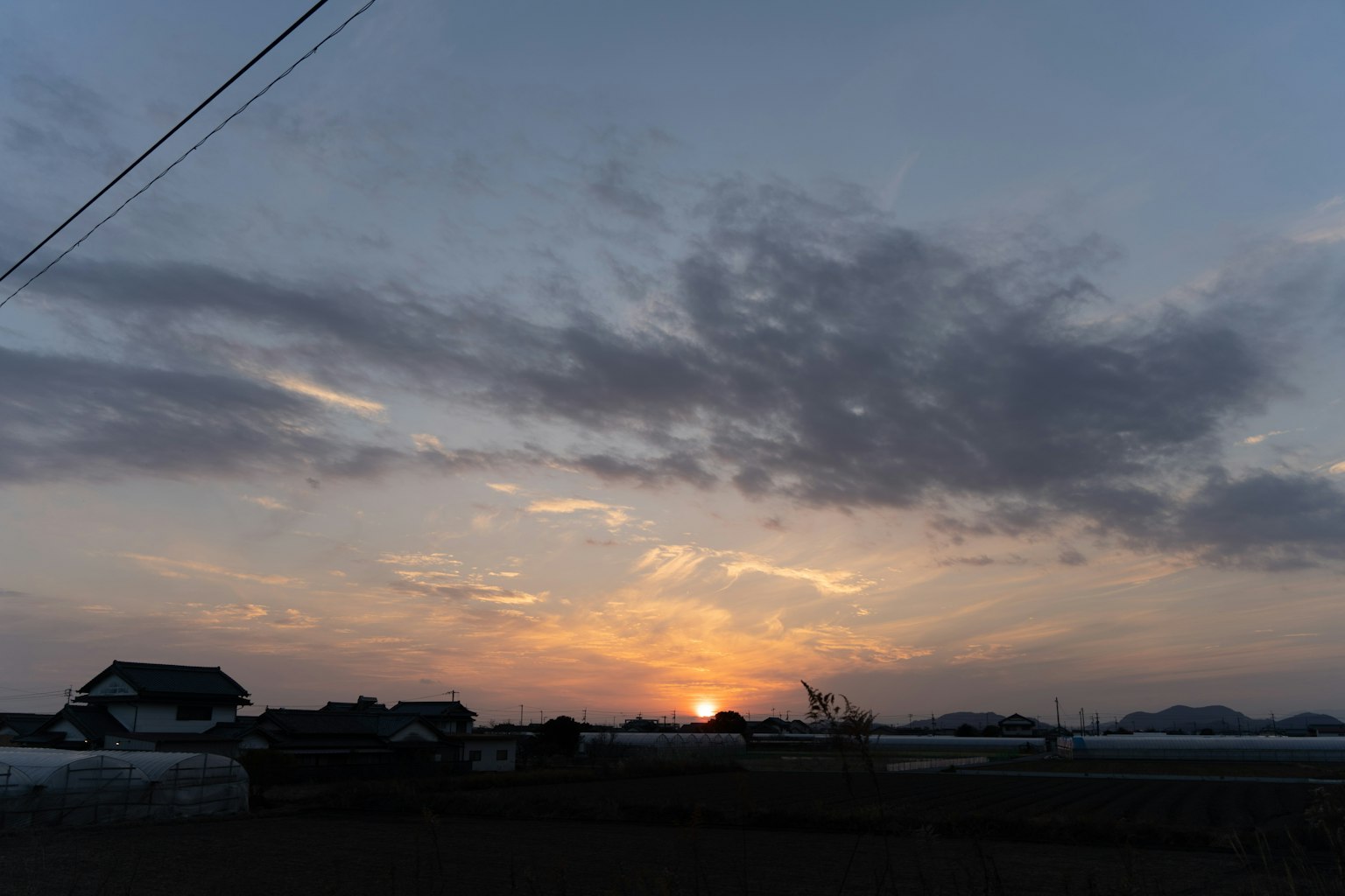 Beautiful sunset landscape with clouds and setting sun