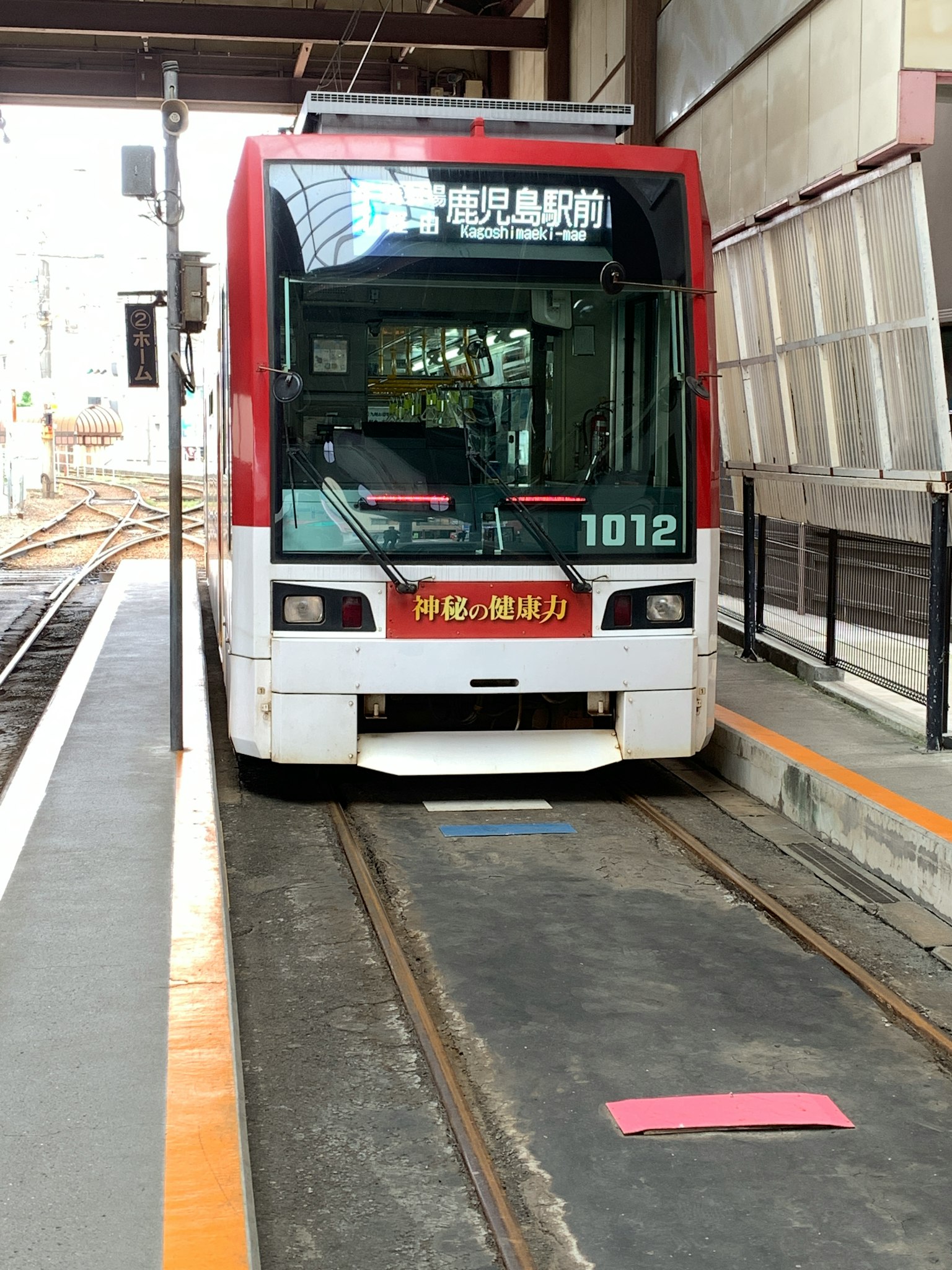 Xe điện màu đỏ đỗ tại nhà ga