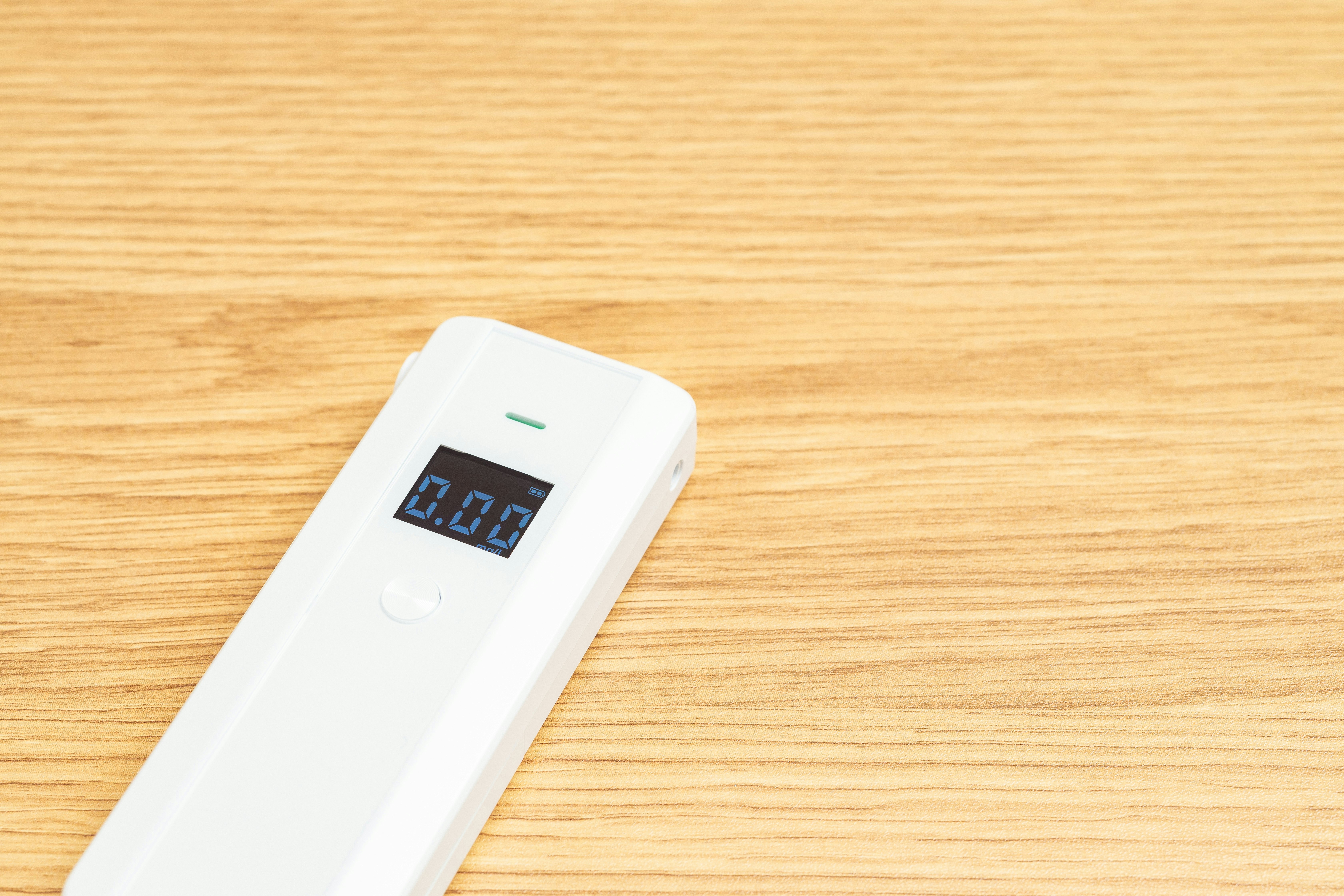 digital thermometer on a wooden desk