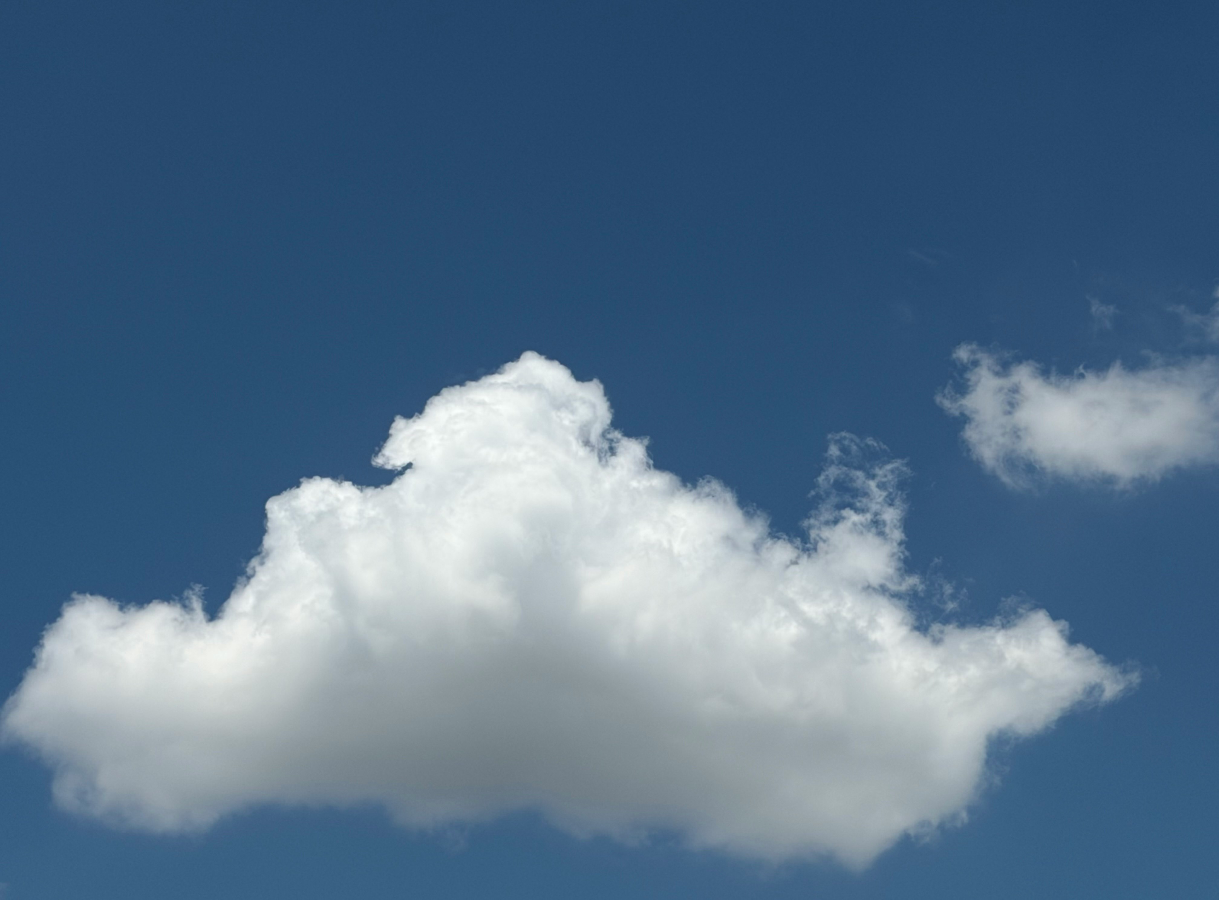 white clouds floating in a blue sky