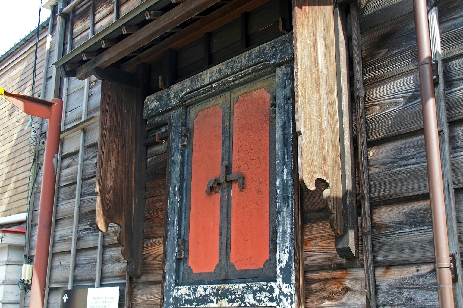 Old wooden door with red decorations