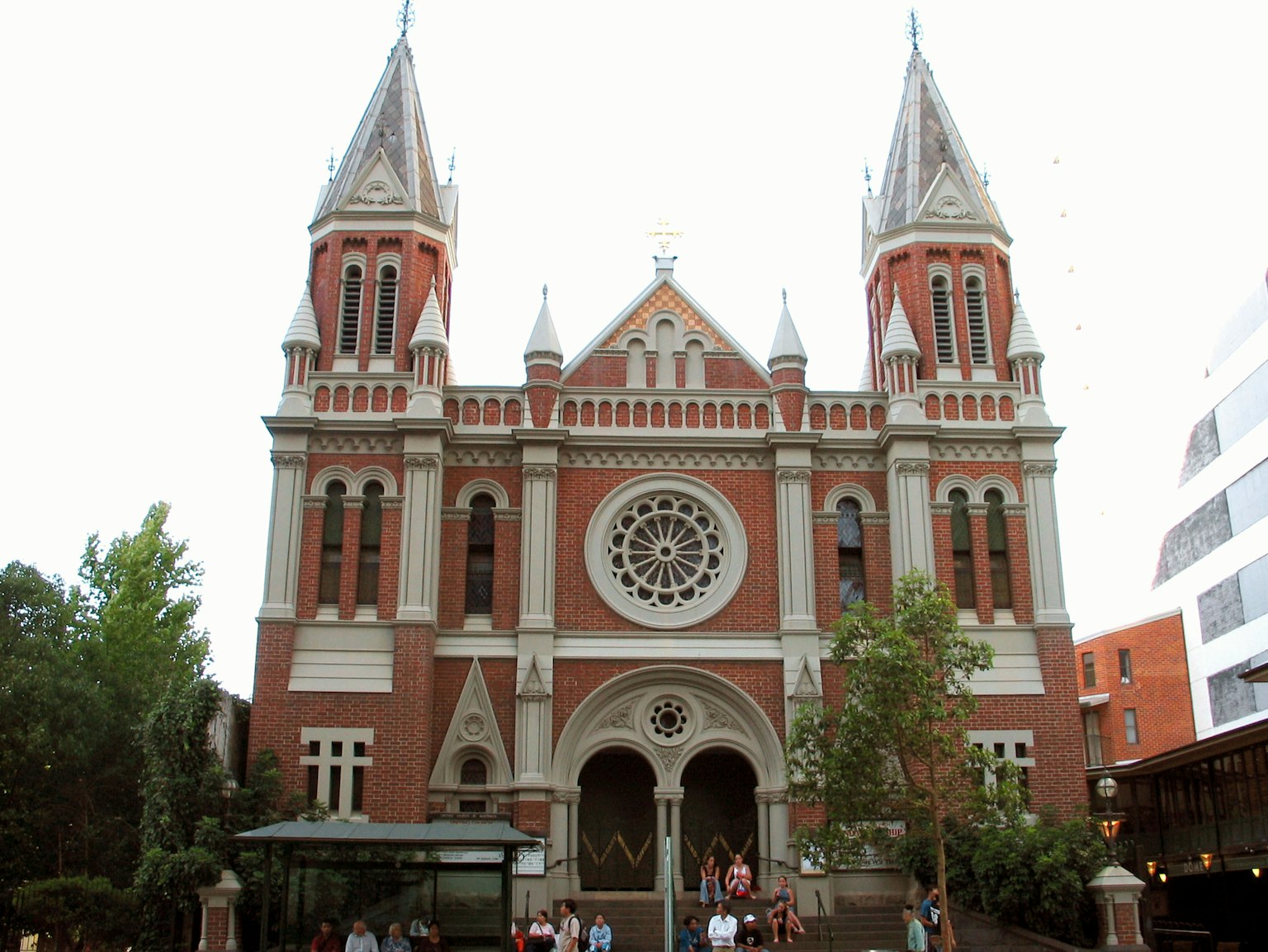 Beautiful red brick church with spires and a large rose window