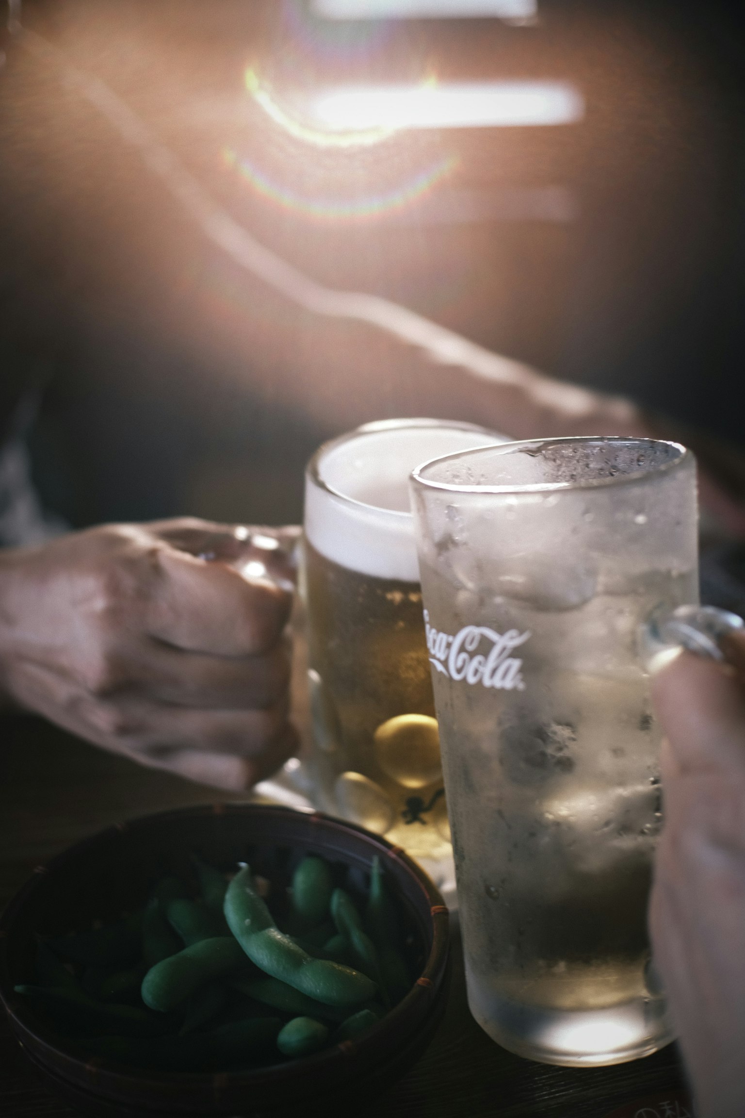 Image showing hands holding beer and Coca-Cola glasses