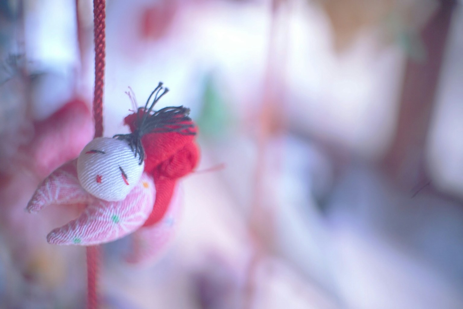 Sfondo morbido con un giocattolo di peluche rosso e bianco appeso