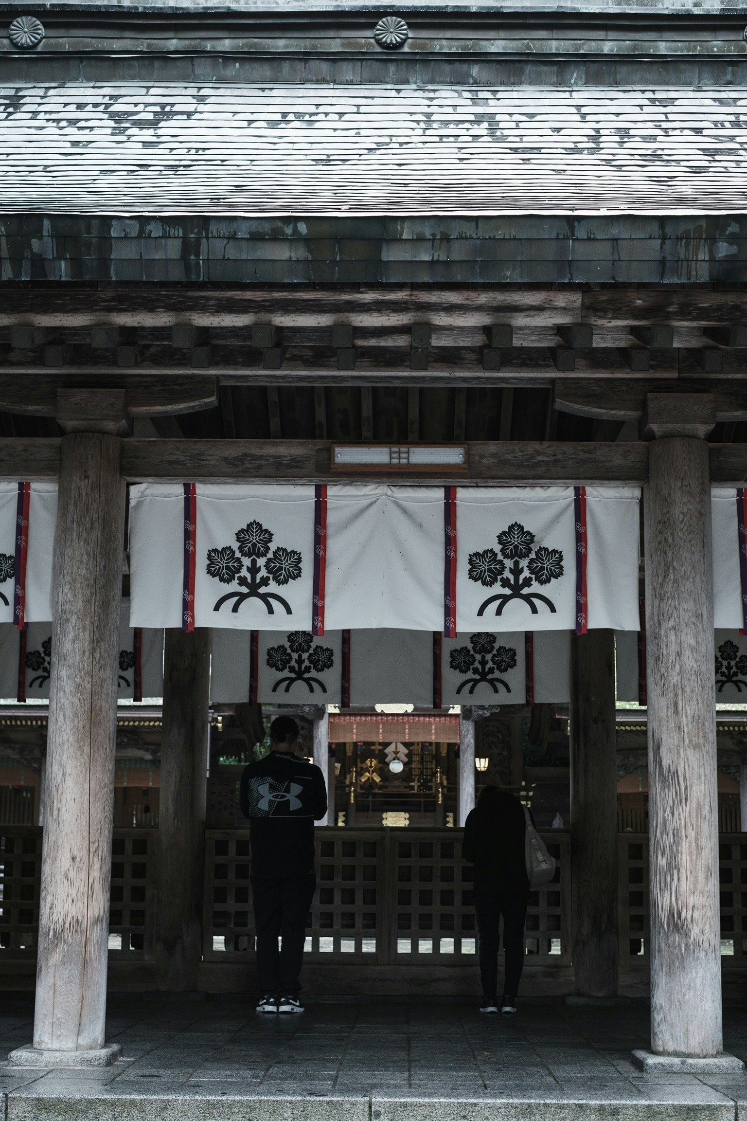 Torii gate with white banners and black crests