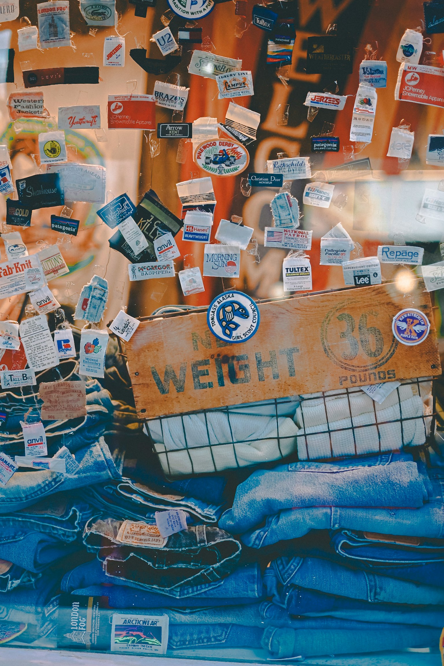 Image of a window display featuring denim and various stickers
