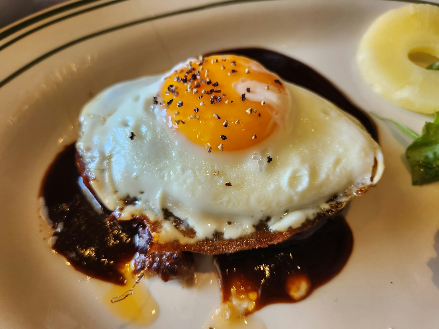 Burger topped with a fried egg and sauce