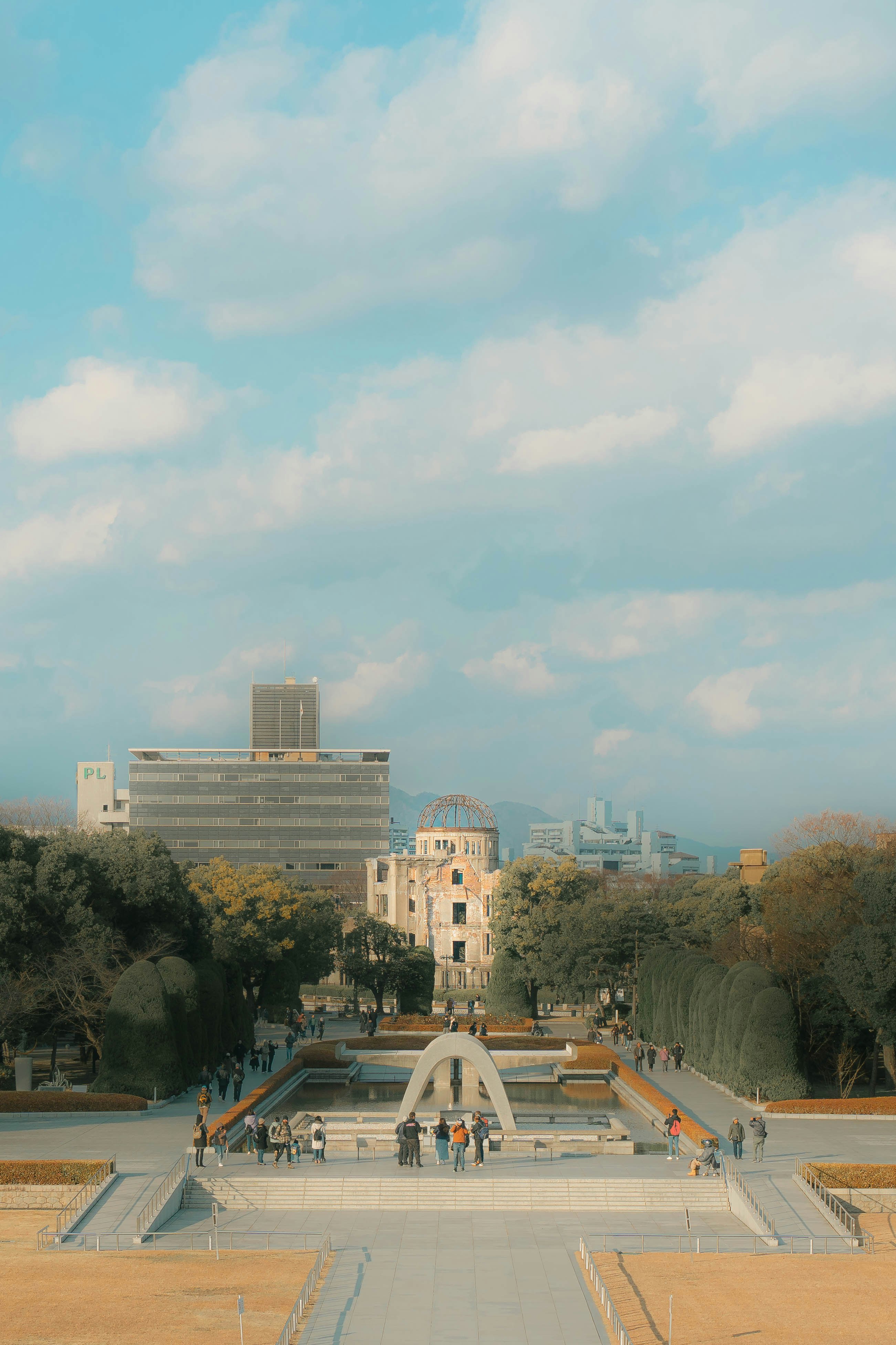 Quiet park with stone ruins and distant city high-rises