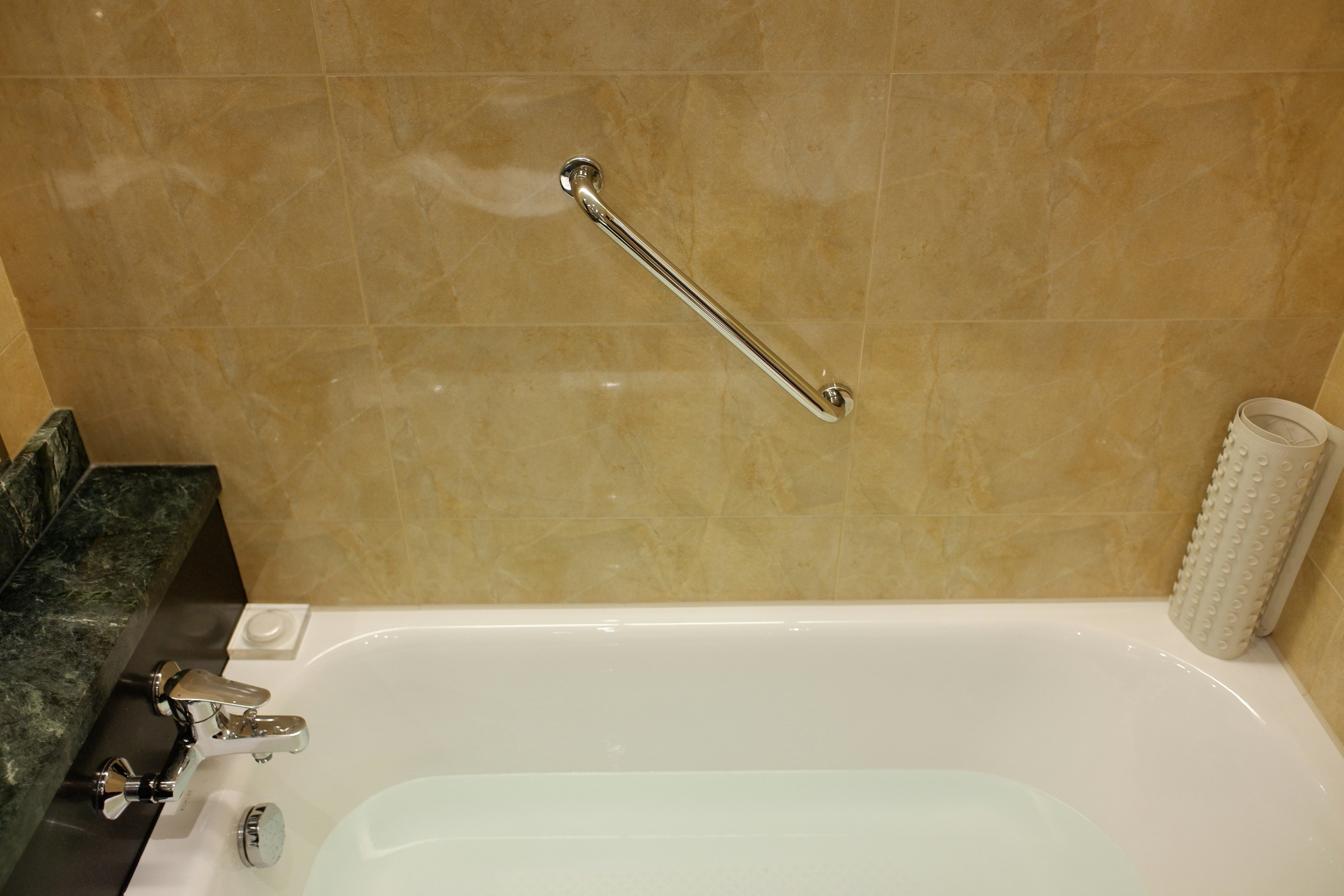 zona de lavabo del baño con bañera, grifo y toalla
