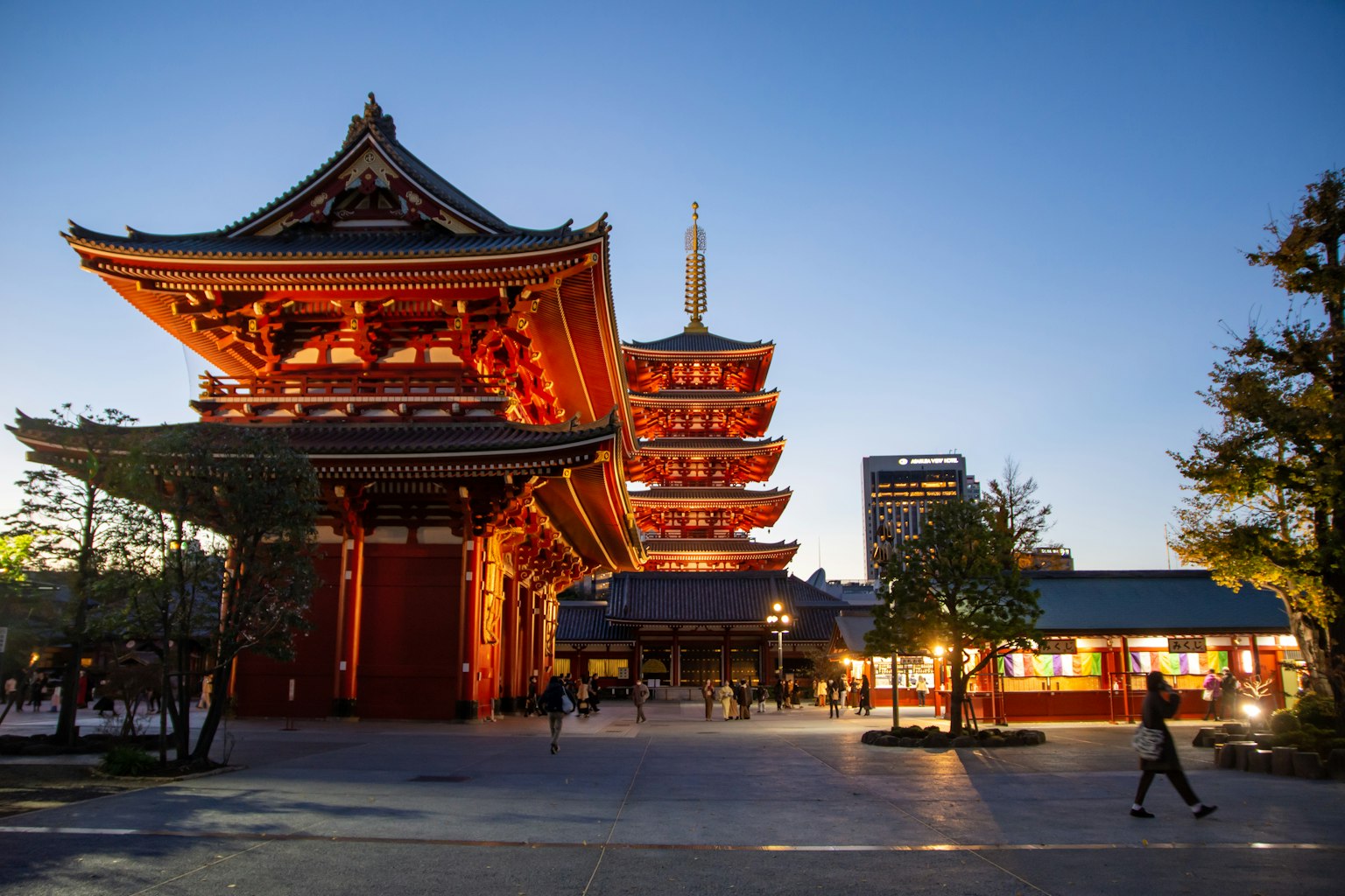 Beautiful view of a Japanese temple at dusk featuring traditional architecture and red decorations