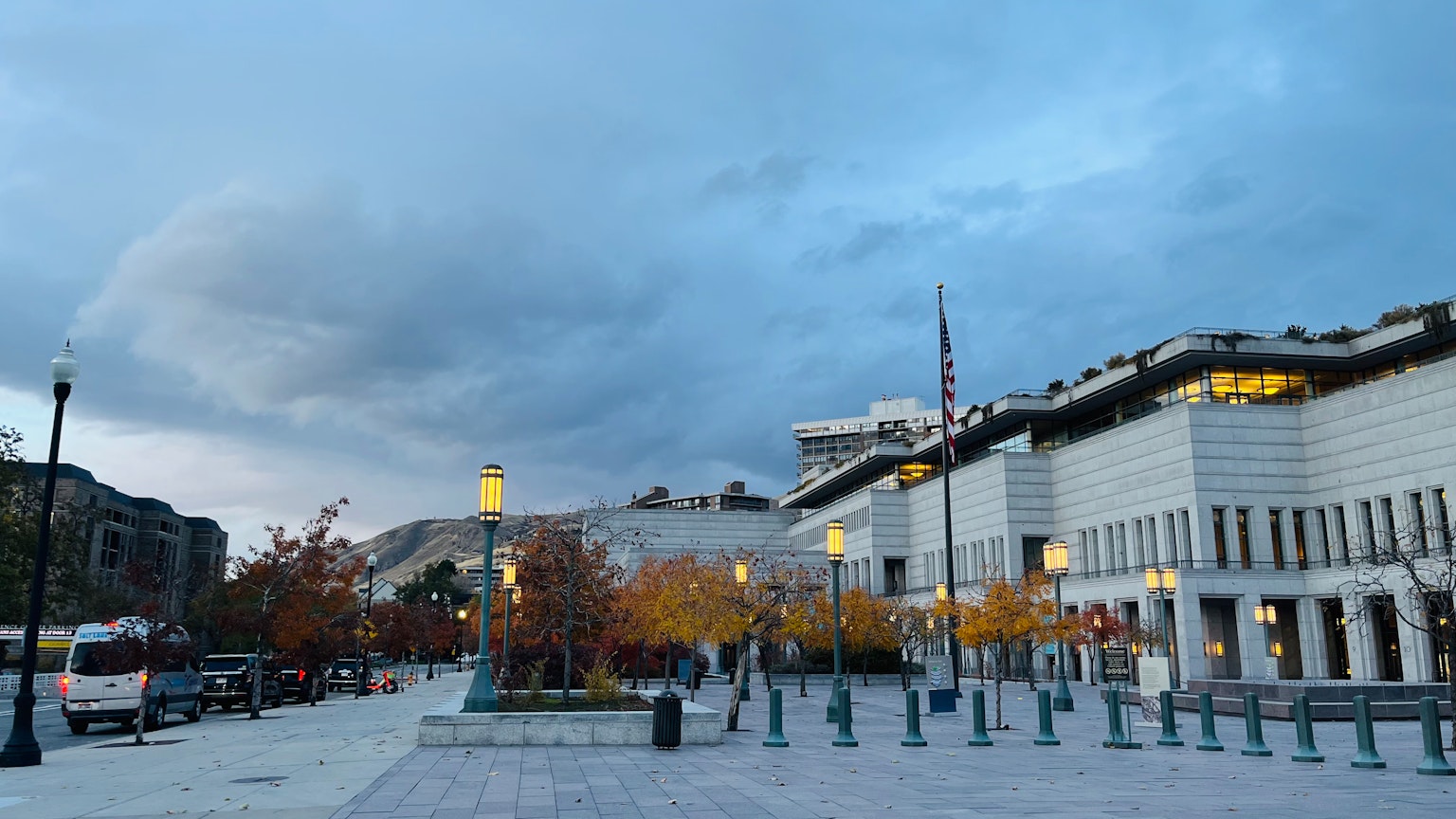 Urban plaza with autumn trees and a cloudy sky