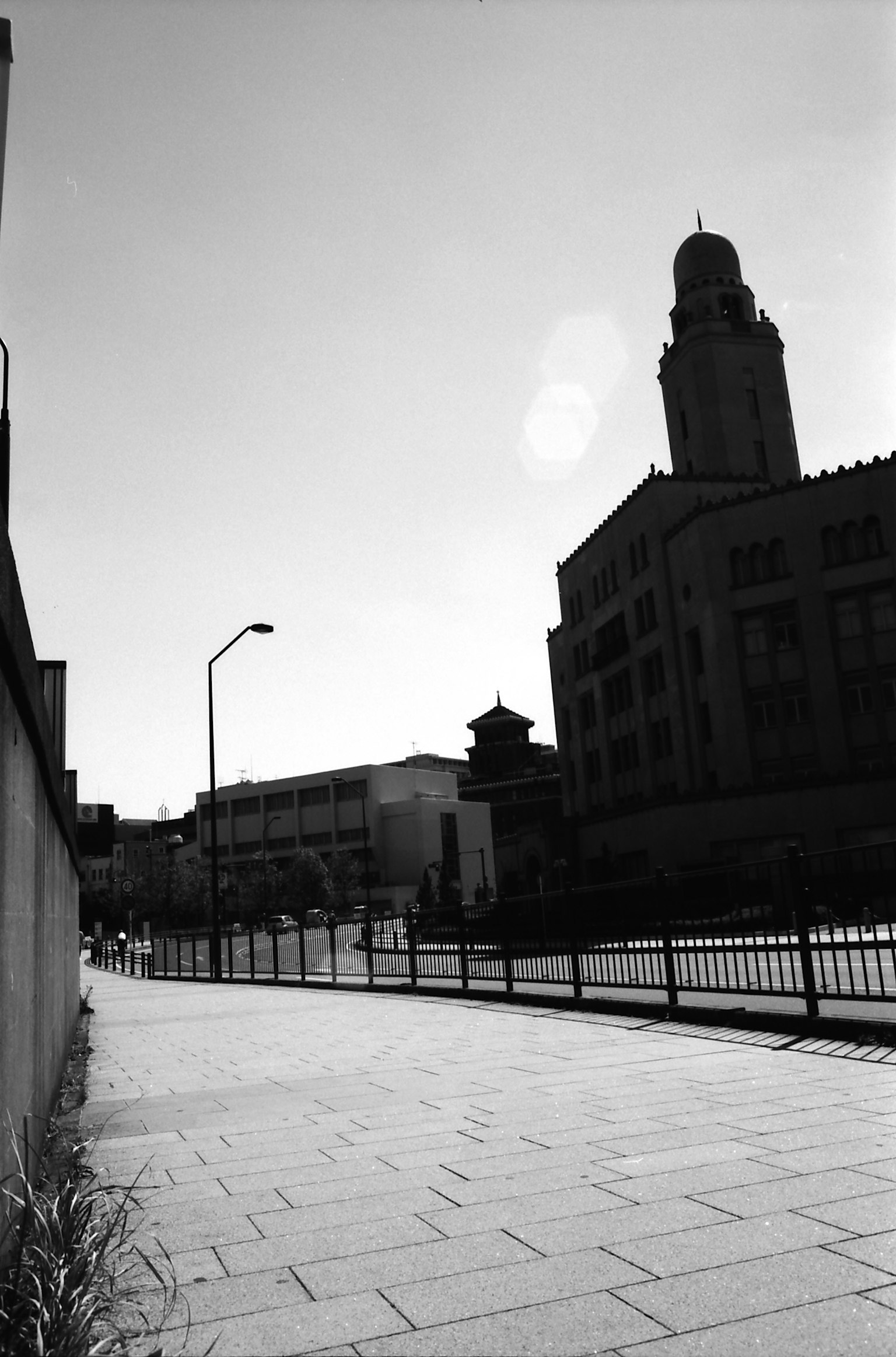 A quiet street scene featuring black and white buildings and architecture