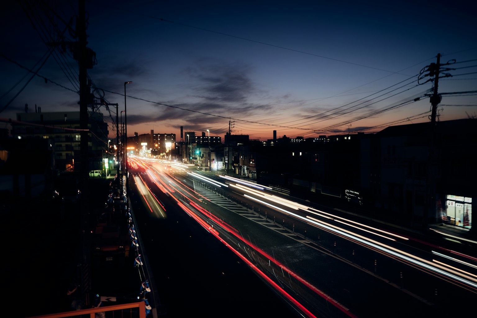 Cityscape at dusk with flowing car lights